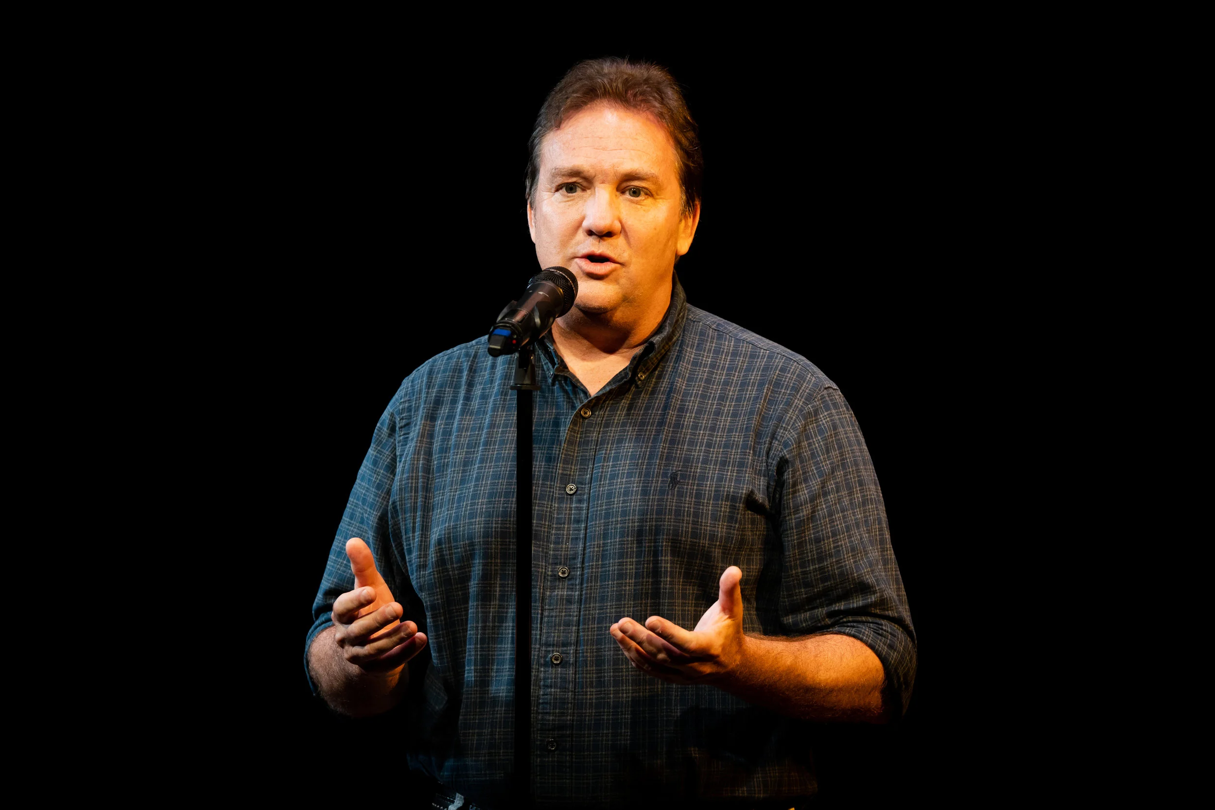 Konrad Hughen shares a story with the Story Collider audience at Caveat in November 2018. Photo by Zhen Qin.
