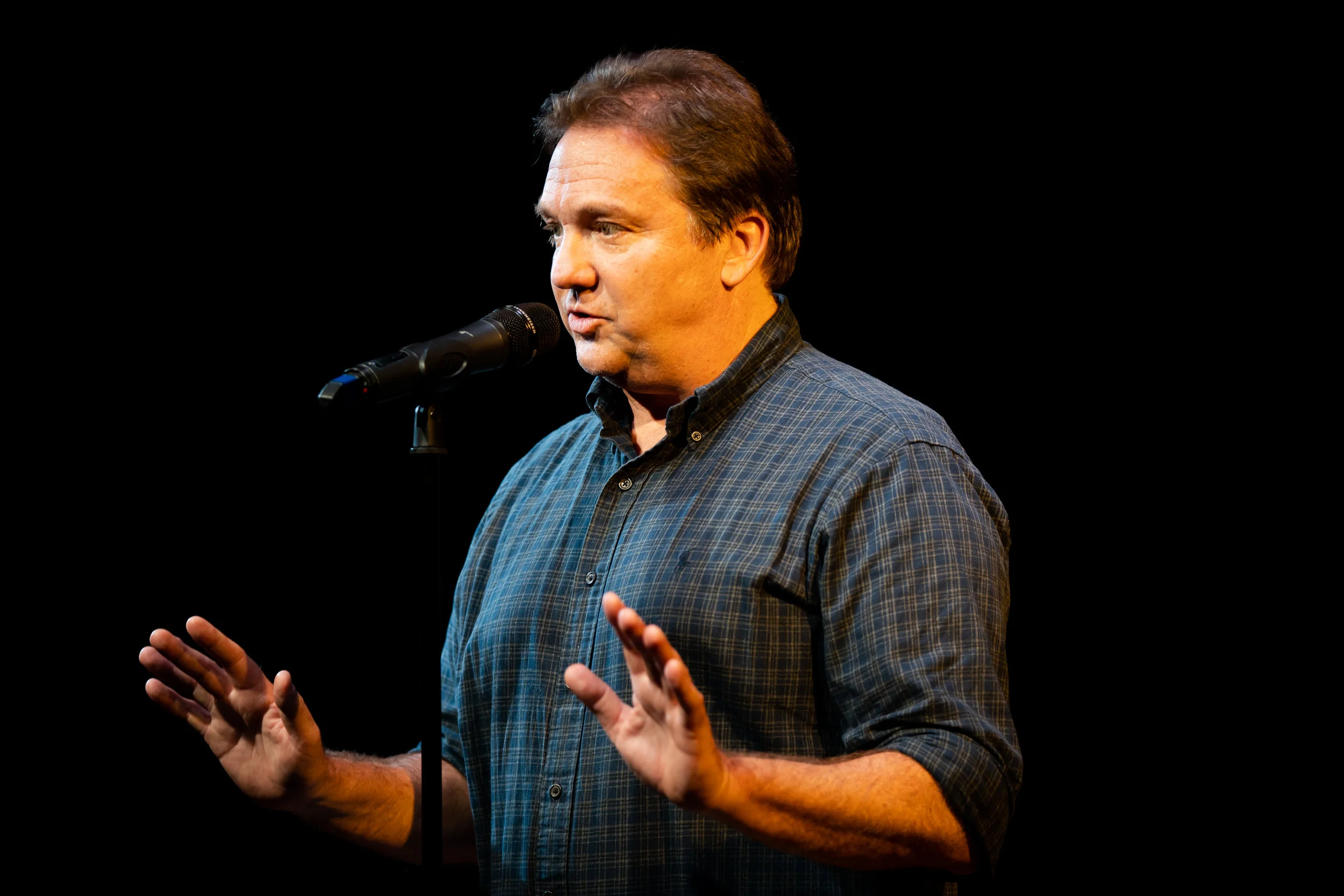 Konrad Hughen shares a story with the Story Collider audience at Caveat in November 2018. Photo by Zhen Qin.