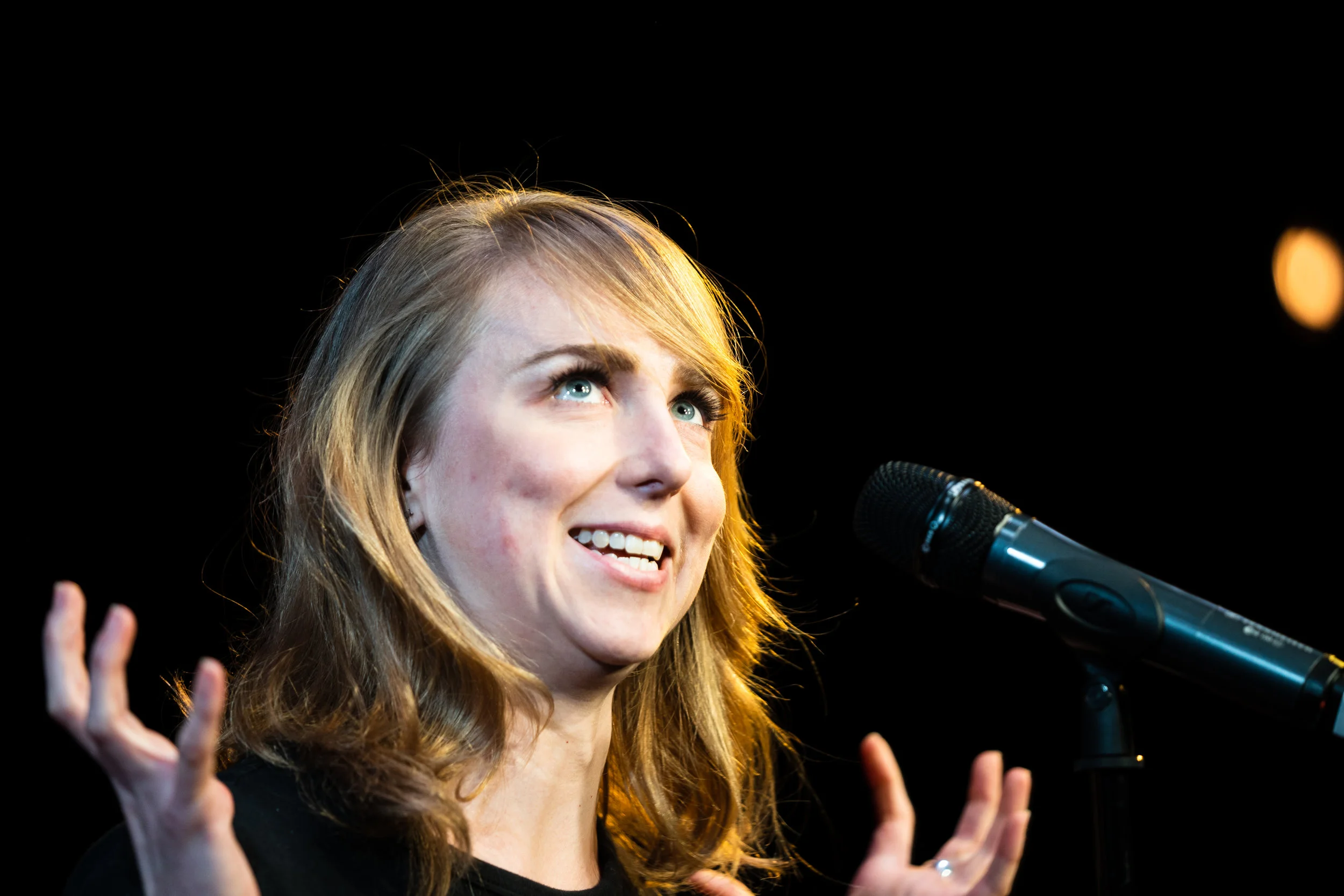 Adrien Behn shares her story with the Story Collider audience at Caveat in New York City in December 2018. Photo by Zhen Qin.