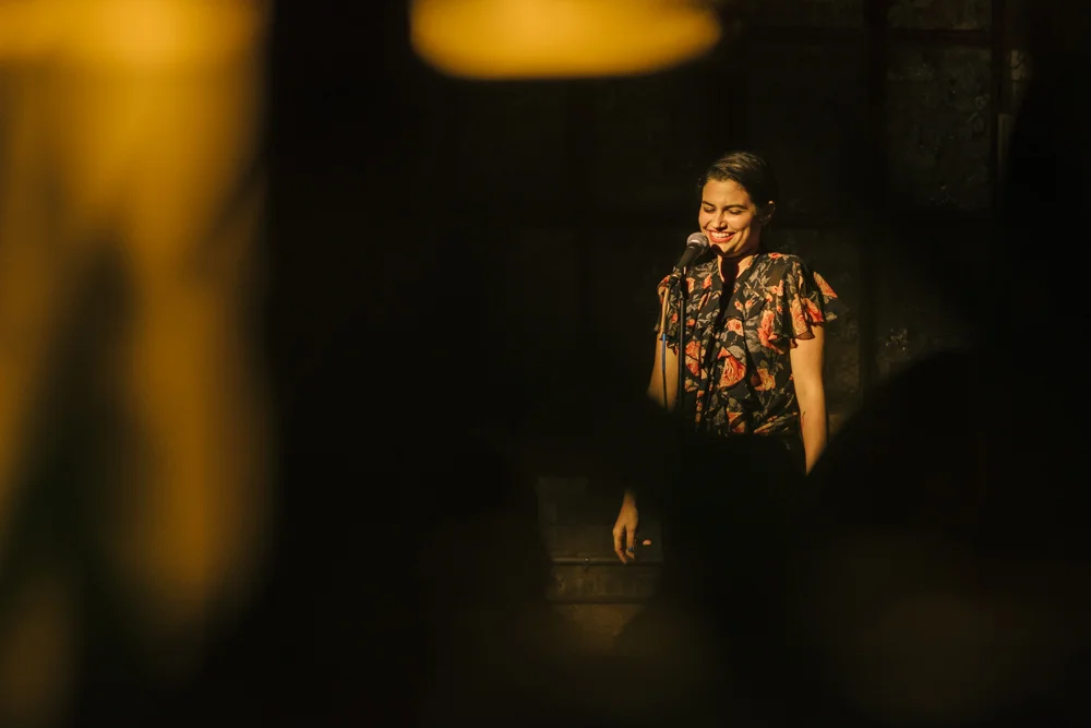 Anna Miller shares her story with the Story Collider audience at Dandy in Milwaukee, WI in June 2019. Photo by Mahdi Gransberry.