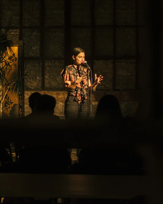 Anna Miller shares her story with the Story Collider audience at Dandy in Milwaukee, WI in June 2019. Photo by Mahdi Gransberry.