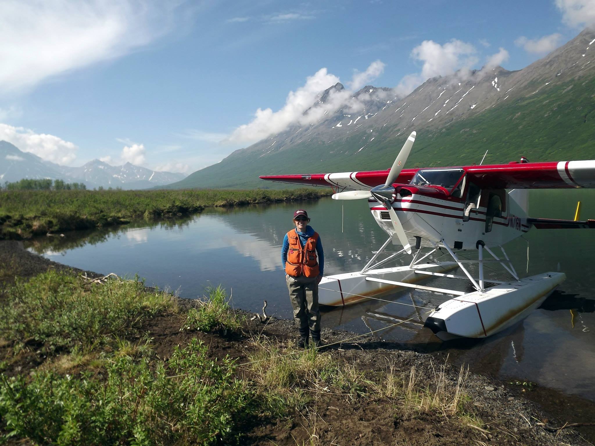  Anna Peterson standing in front of a float plane in Alaska. Photo courtesy of Anna Peterson. 
