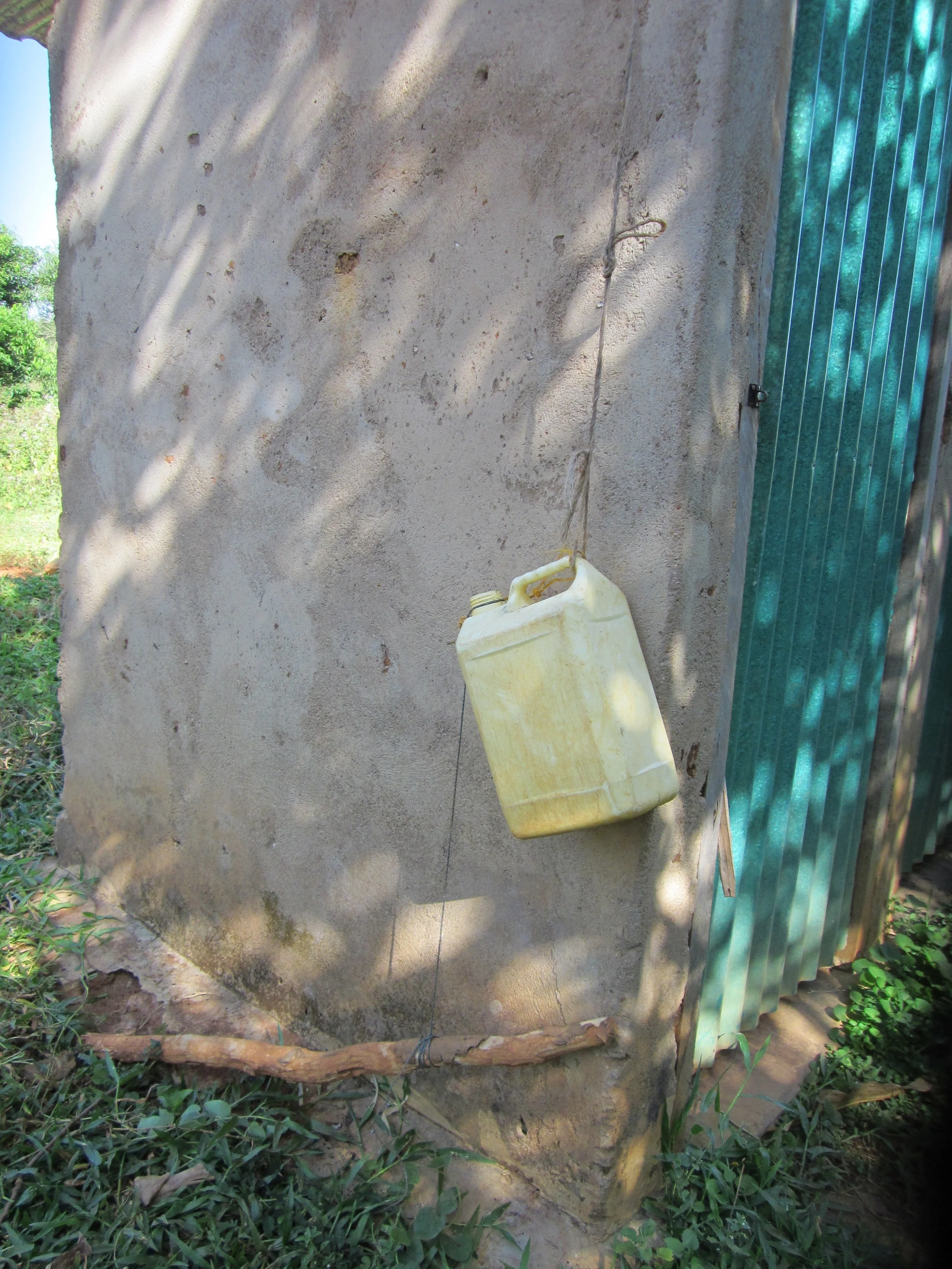 Water can for hand-washing outside of a latrine
