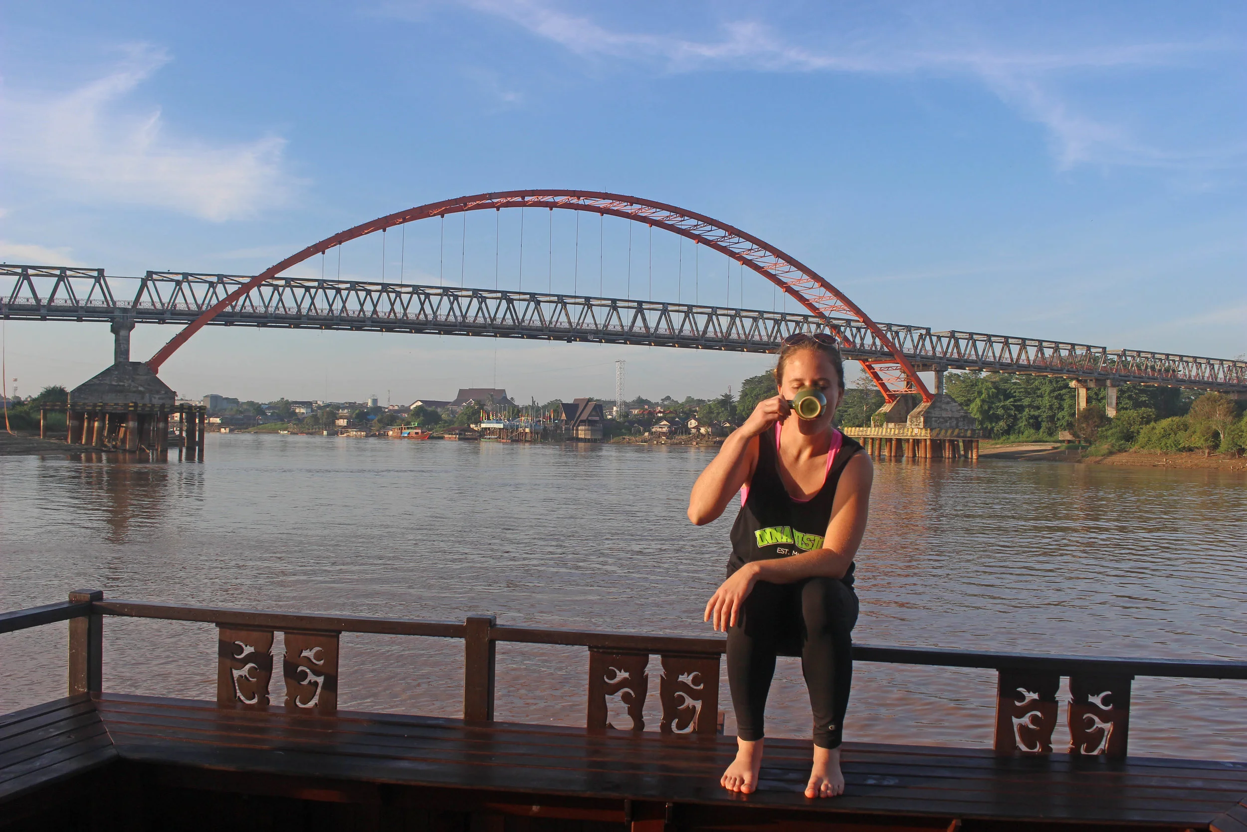 Drinking coffee on the boat near Palangkaraya's famous bridge