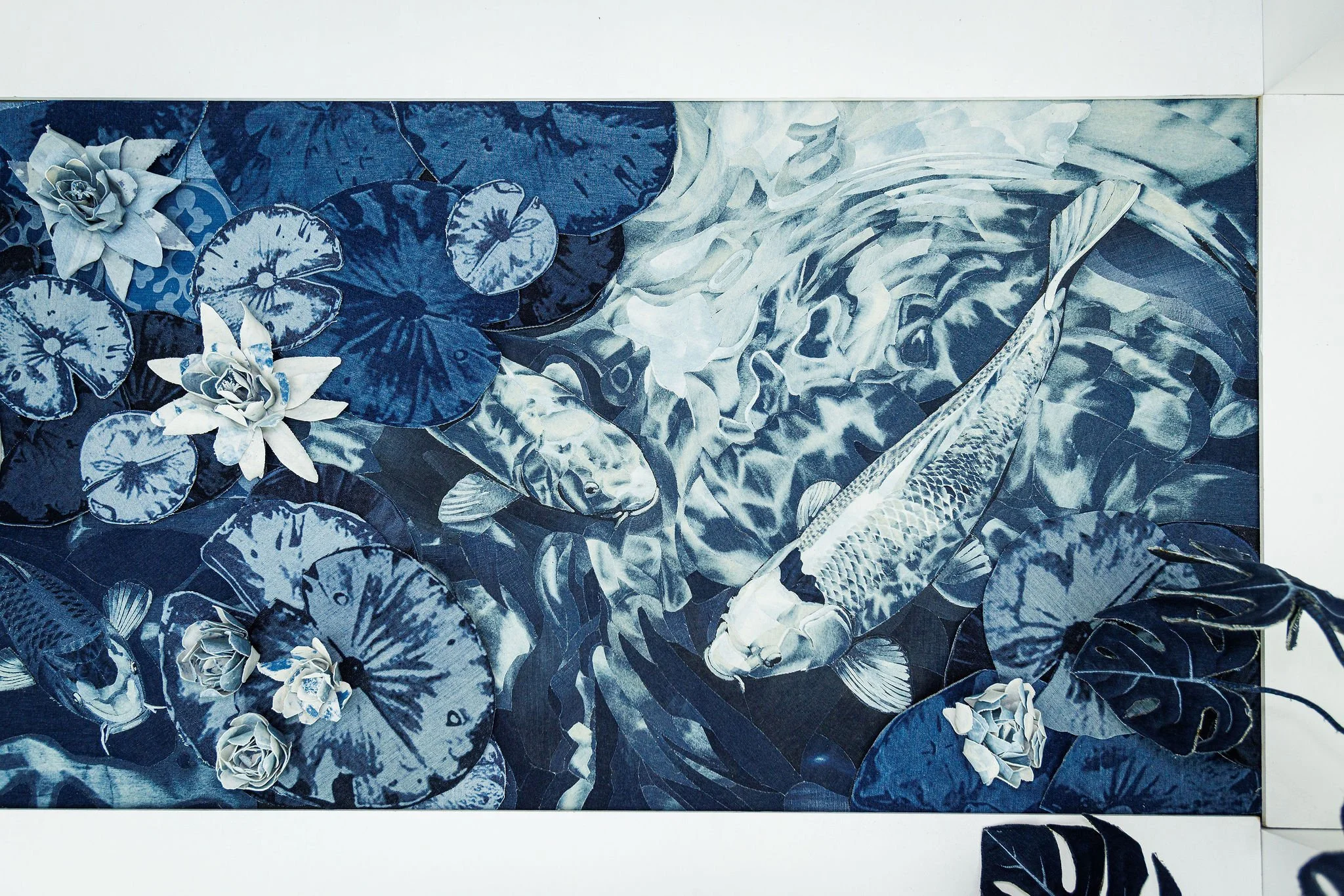 Detail of the Koi pond in The Secret Garden in Textile Art Redefined at the Saatchi Gallery, London 2026. Ian Berry’s Denim Secret Garden installation 