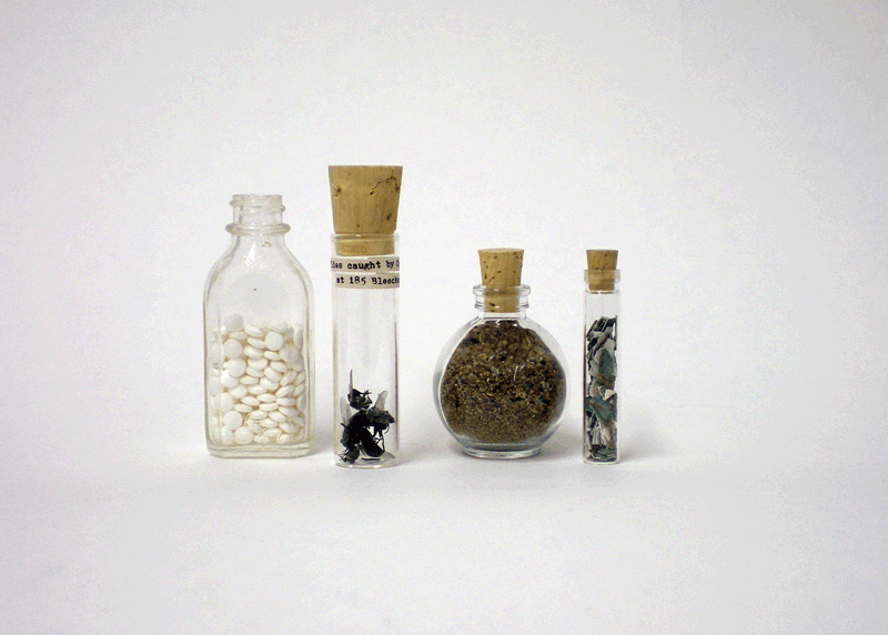Got A Girl Crush On : Jackie Mock’s ongoing project, traveling the United States documenting found relics and strange objects.
winesburgohio :
“From Left:
1. 1.8 years in sugar pills 2. flies caught by Cat Stevens at 185 Bleecker Street 3. sand from underneath carmine street collected when a water mane burst on November 15, 2009 4. paint chips found under seven layers of white paint on my windowsill”
Other favorites from her voyages include:
“ 2. Paint chips from the exterior windowsill of a bank robbed by Bonnie and Clyde in Stuart, Iowa on April 16, 1934.”
“ A banana I ate on October 26, 2009 sewn and stuffed with the New York Times from that day.”
See more at her strangely enthralling/addictive site, here .