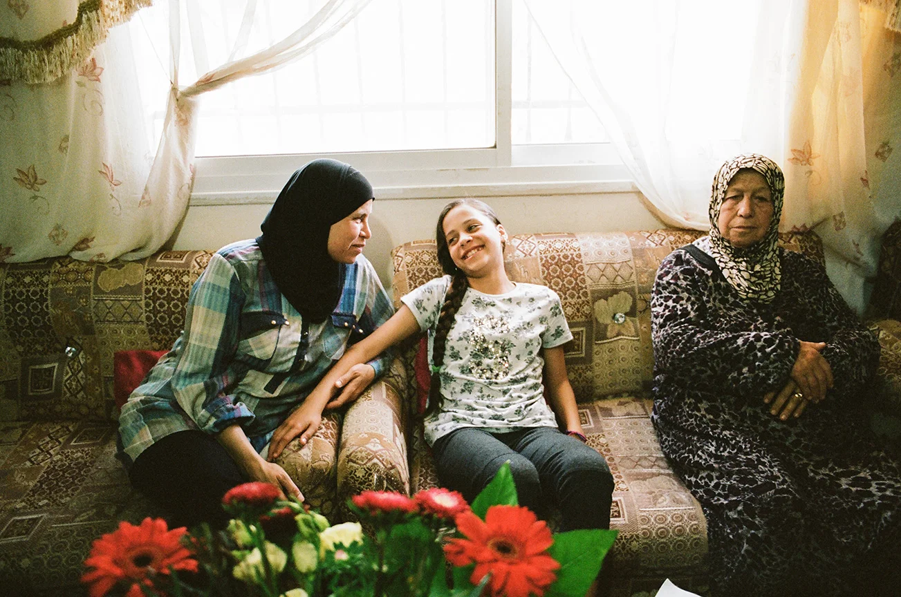 Janna with her mother Nawal and grandmother at home in Nabi Saleh. Janna tells her mother all about her upcoming final exams at school that she’s nervous about and how she’s very excited about spring break.