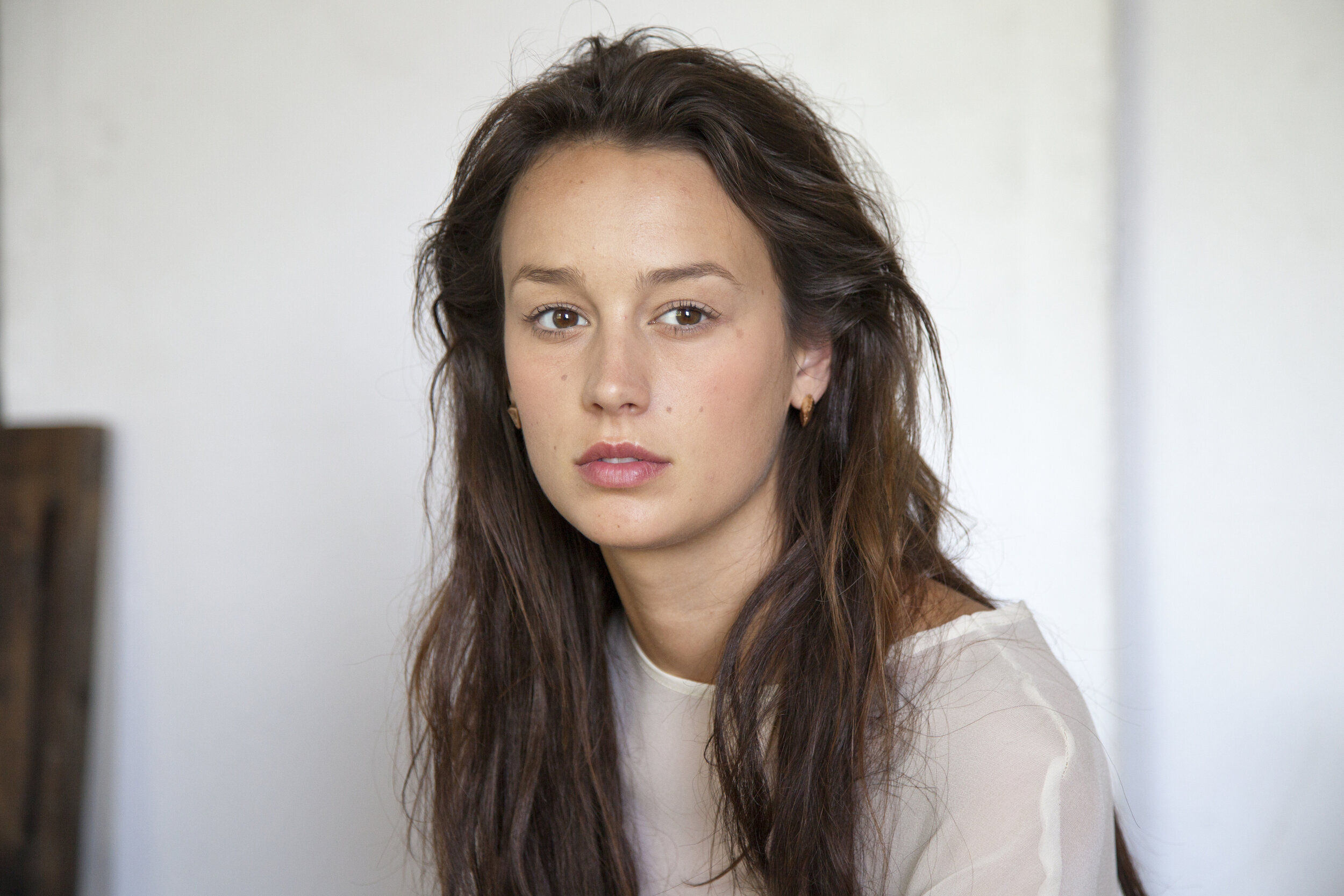 Abi Penhale wearing Large Unmatching Stud earrings in rose gold vermeil of recycled Sterling silver with sapphires from GINA MELOSI's //SHATTEREDfragments// collection