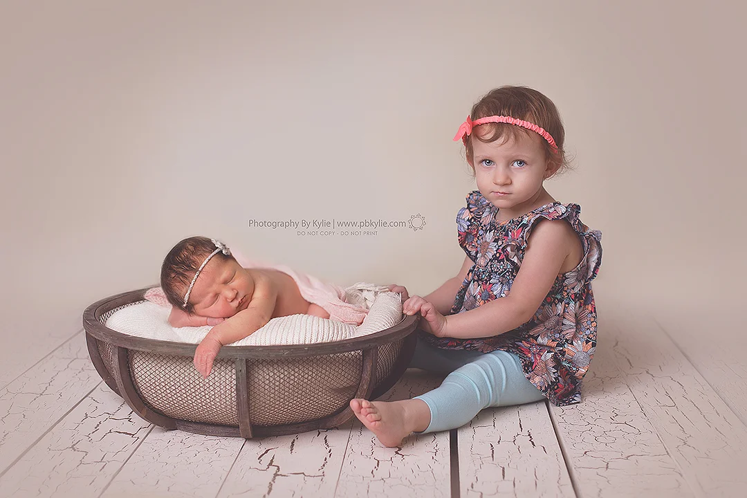 Emily, 7 days old. Abigail, 22 months old.... and clearly not impressed.