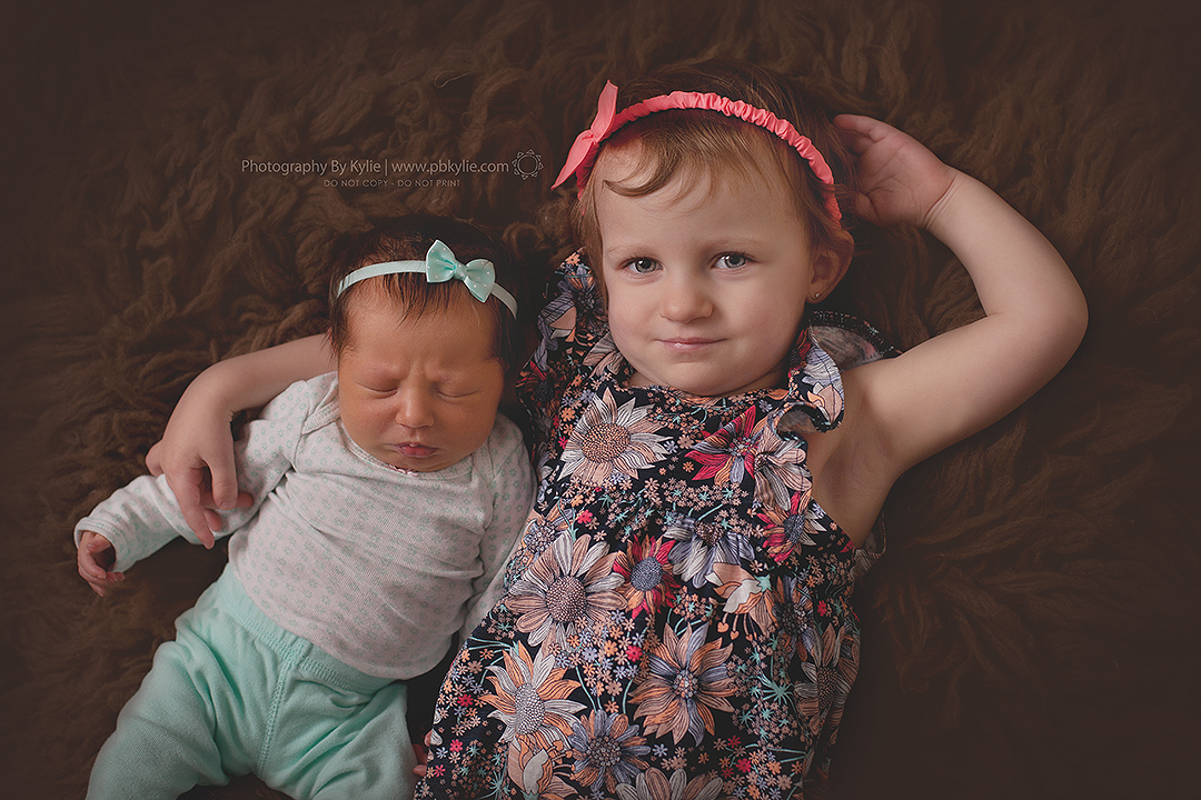 Emily, 7 days old. Abigail, 22 months old.