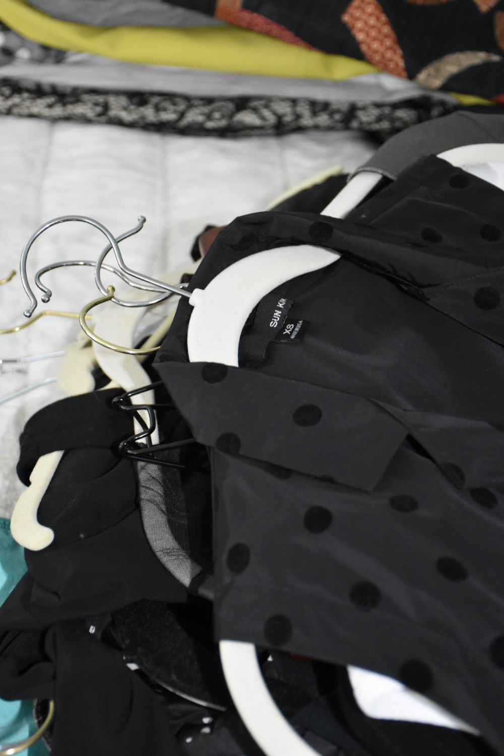 A stack of items to go through. We kept this long, polka dot vest!