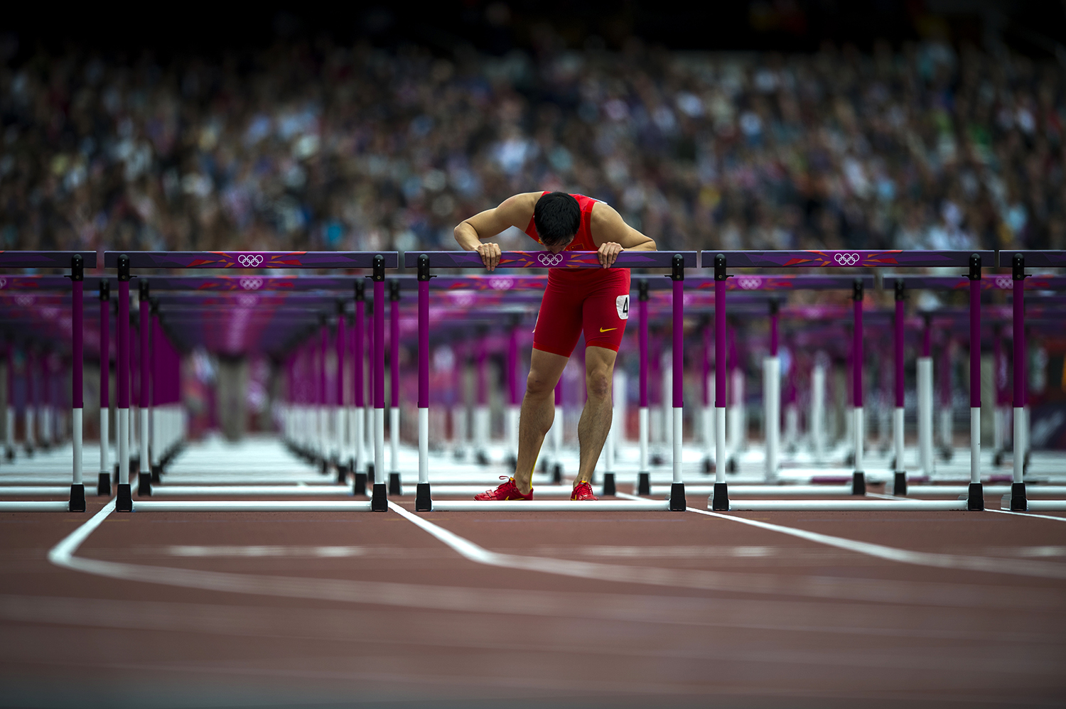 Lui Xiang. 110 meter hurdler from China. Olympic champion, world champion, world record holder. He injured his Achilles tendon at the start of the race in London. Hobbled to the finish line, and kissed his hurdle to say goodbye to the sport. One of the most emotional moments I’ve witnessed in more than 30 years of covering athletics. 