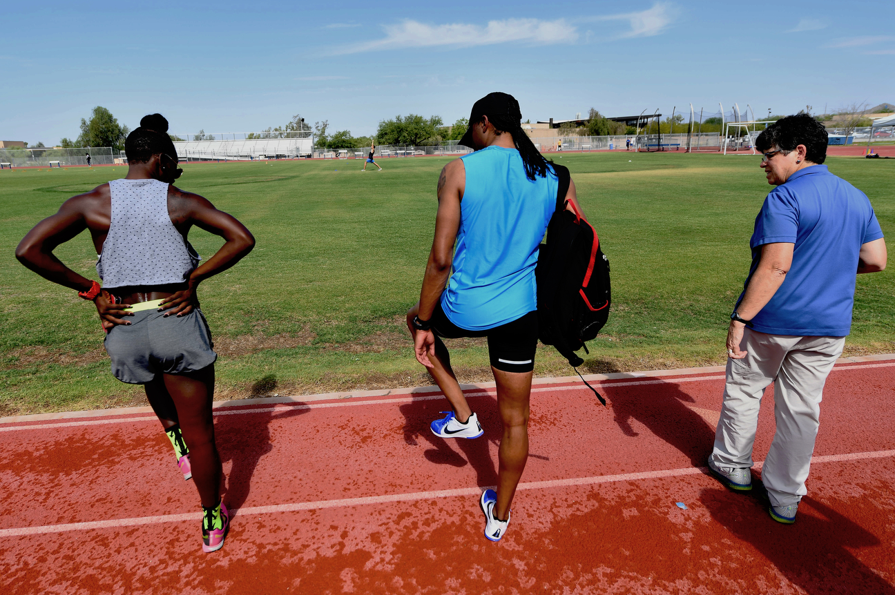 A drug-testing official from the United States Anti-Doping Agency is to Merritt's right as he does some stretching. He takes medication for his kidney every 12 hours, but those drugs are either neutral or could slightly weaken muscle -- they're definitely not performance-enhancers.