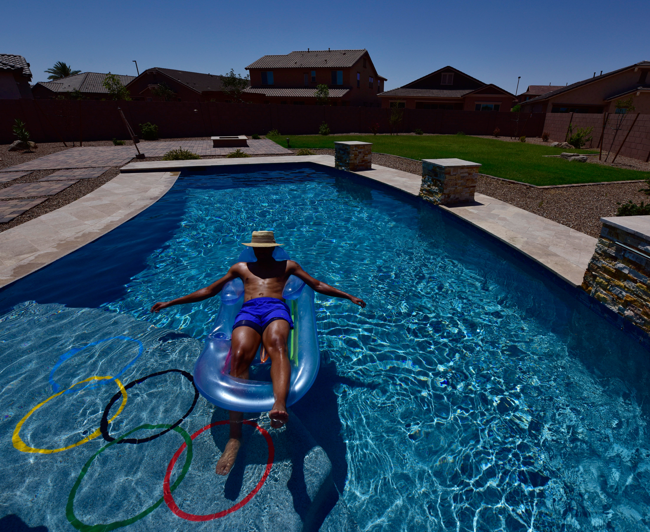 It's easy to see the Olympic rings painted on the bottom of Merritt's pool. Look a little more closely, and you might see the scar left on his abdomen from his kidney transplant.
