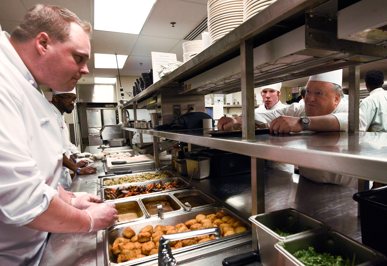 Working his "15th or 16th" Derby by his estimate, Robin Rosenberg, right, the VP chef du cuisine at Levy Restaurants, prepares a plate to be served at the Turf Club as chef David Siegler looks on. There are 1,000 people serving the entire Downs, and a total of 20,000 meals are served. In 2015, there were 127,000 mint juleps served on the property.