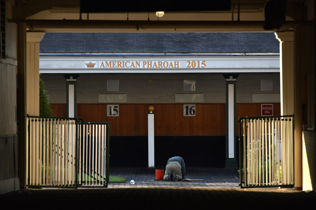 Gary "Moonie" Leunberger replaces a tile in front of a tribute to Triple Crown winner American Pharoah. "I love enjoying people enjoying themselves at Churchill."