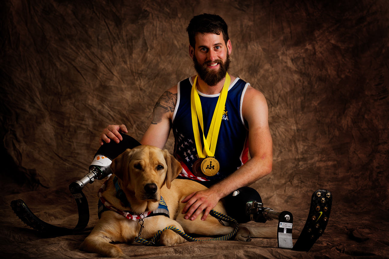 Stefan Leroy, 25, sits with his service dog, Knoxville. Leroy served in the Army and is from Santa Rosa, California, but now resides in Jupiter, Florida. He won a gold medal in sitting volleyball.