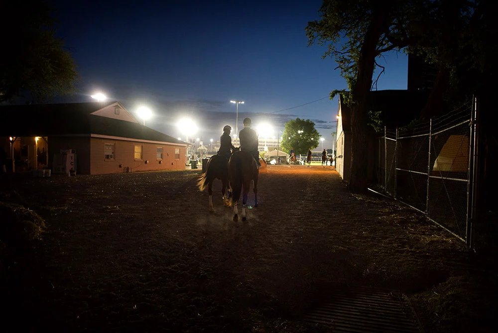 An exercise rider leads Hernandez and his horse to the track for a morning workout on Wednesday at Churchill Downs. For Hernandez, 31, horse racing is a family tradition. Brian Hernandez Sr. had a long career as a jockey at Delta Downs in southwest Louisiana, and his children Brian Jr., Colby and Courtney Hernandez all followed in their father's footsteps to work as jockeys as well.