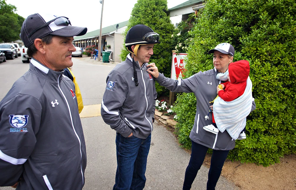 Hernandez's mom, Stephanie, holds his 10-month-old son Benjamin while pulling some lint off her son's jacket. At left is Brian Hernandez Sr., Brian's father. Hernandez started his career at Churchill as a teenage apprentice jockey in 2004.