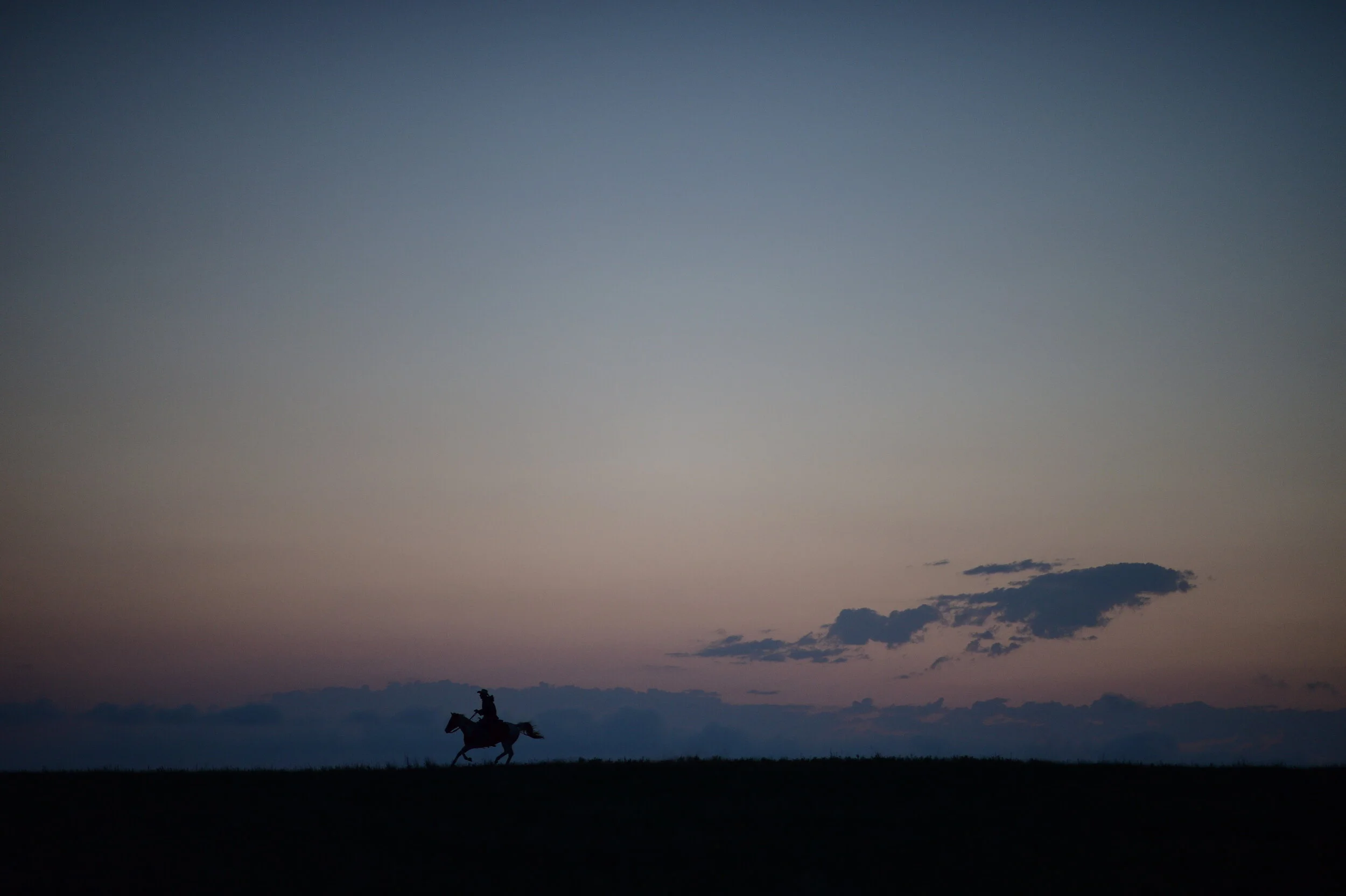  Nebraska NiceKevin and Kelly Morrow riding horses at sunrise 