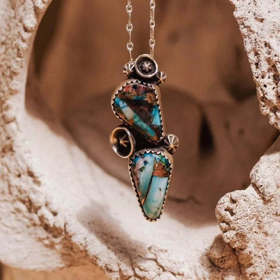 A sterling silver necklace with a purple tide turquoise pendant.