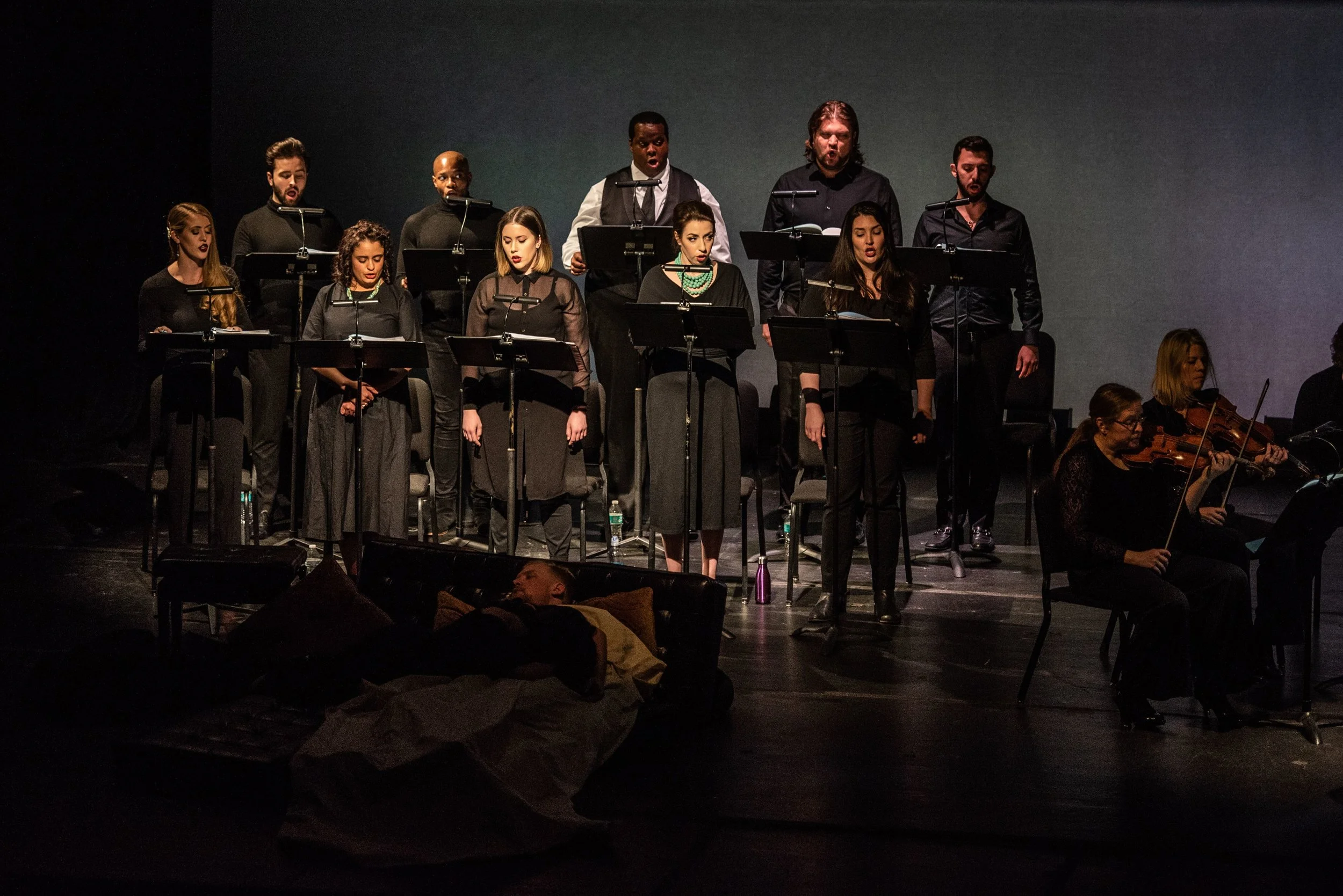 With the unhappy lovers in mortal repose, the chorus (front row, left to right: Meagan Sill, Summer Hassan, Nicole Thomas, Renée Rapier, and Leah Marie Heater; back row, left to right: Joshua Sanders, Frederkick Ballantine, Joshua Conyers, Anthony Robin Schneider, and Matthew Fleisher.) provides closing remarks. Photo by Angelina Namkung for Wolf Trap; courtesy of Washington Concert Opera and Wolf Trap Opera.