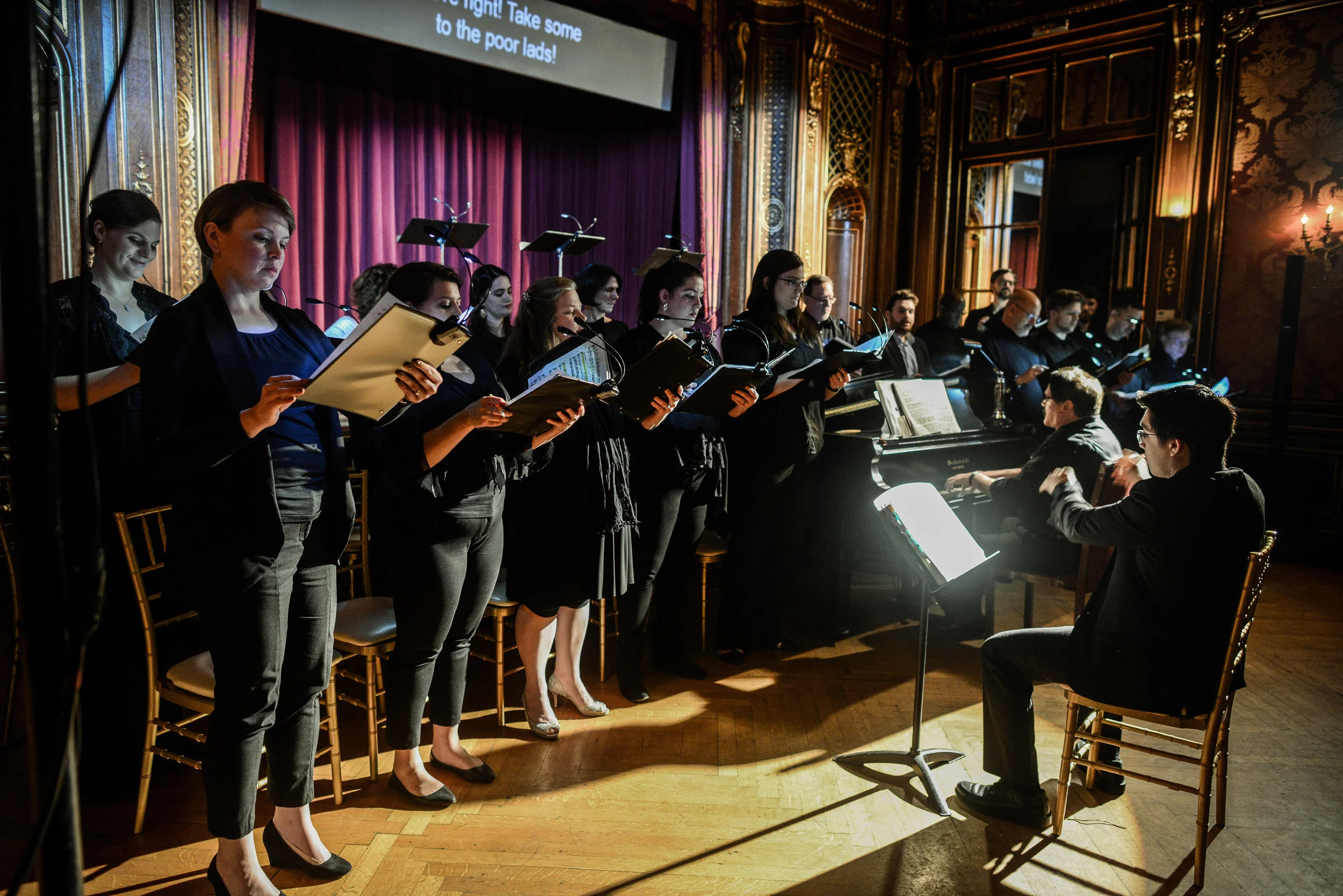 The Baltimore Concert Opera Chorus with Conductor and Pianist James Harp at the piano and Assistant Conductor Ryan Tani seated. Photo by Britt Olsen-Ecker and courtesy of Baltimore Concert Opera.