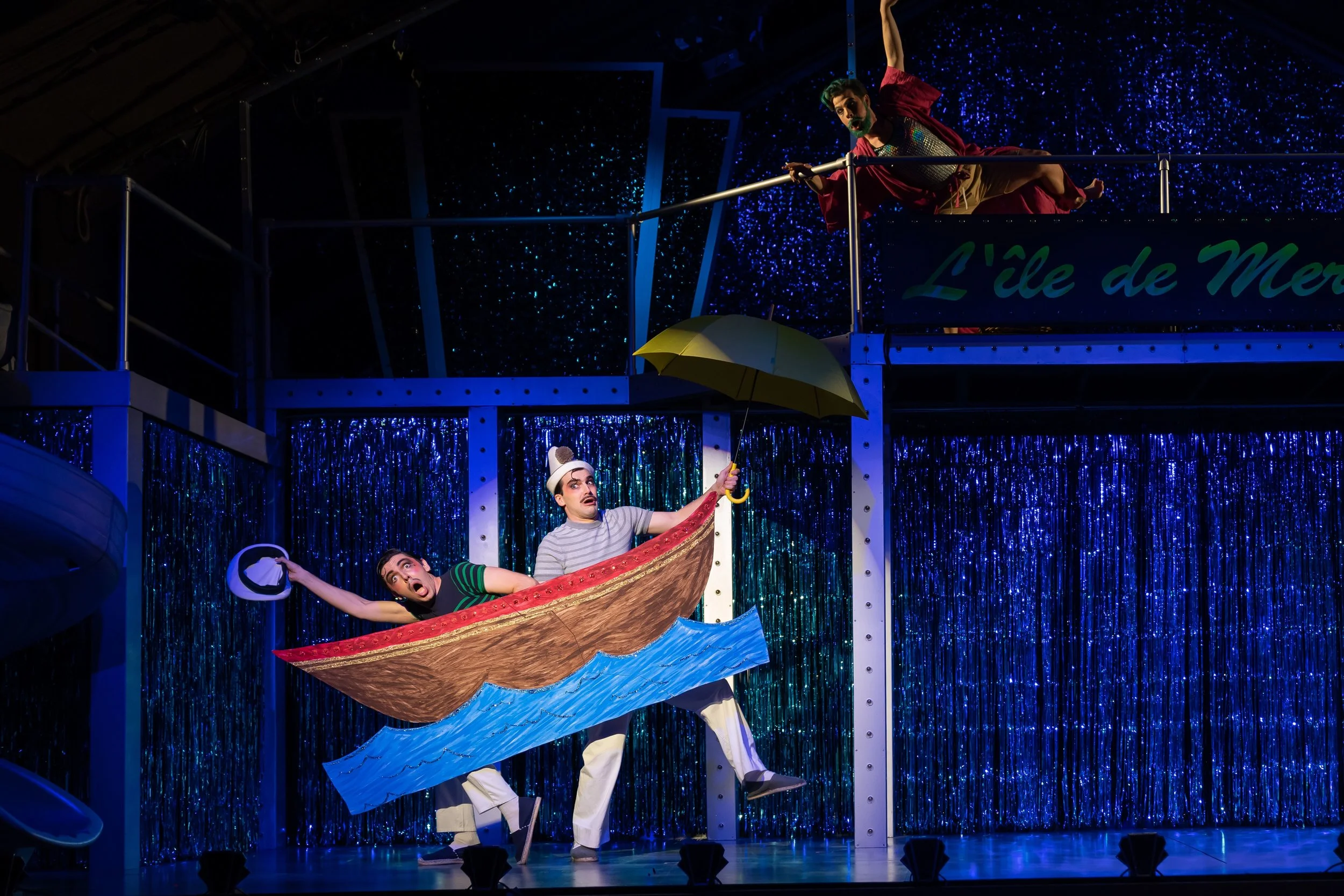 l to r : Two sailors from Paris, Scapin (Daniel Noyola) and Pierrot (Ben Edquist) approach Atlantis as Merlin (Conor McDonald) tracks them overhead. Photo by Scott Suchman; courtesy of Wolf Trap Opera.