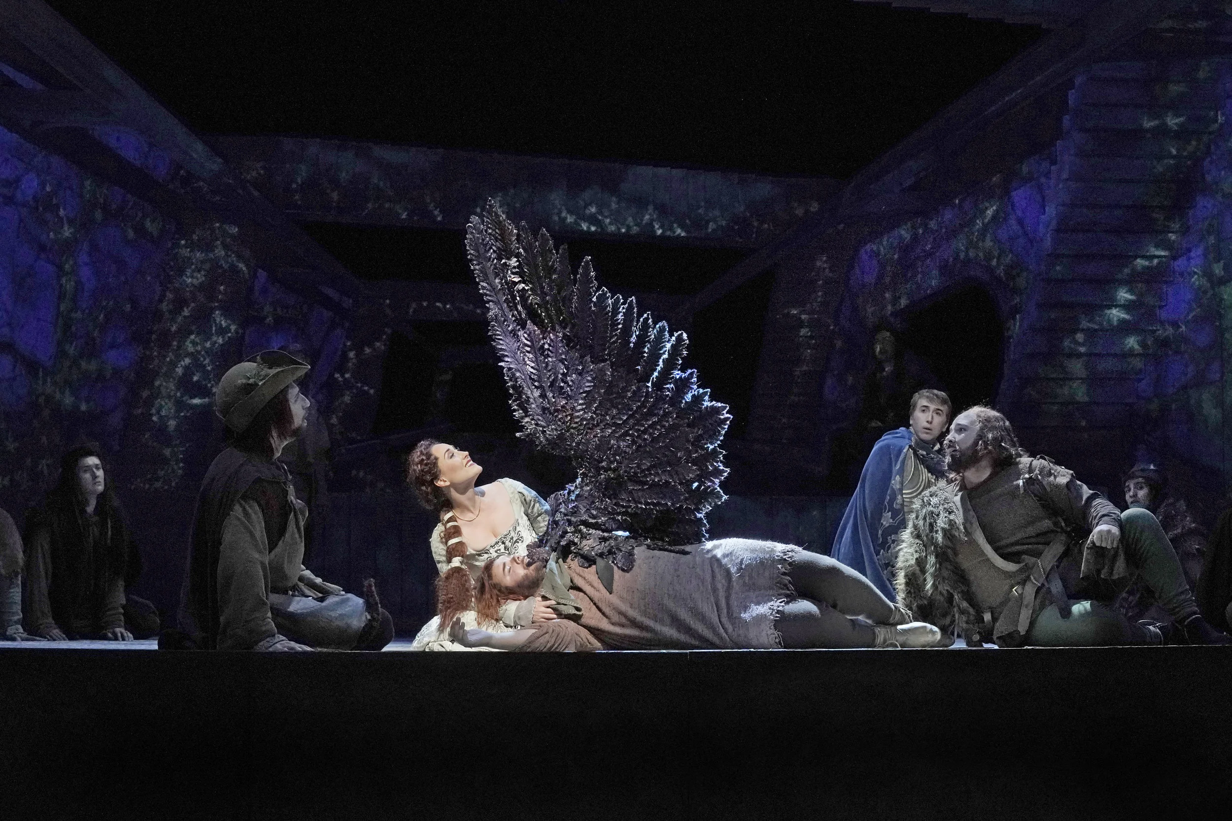 Princess Lyra (Jessica E. Jones) comforts Ben, who was wounded before returning completely to human form. Photo by Ken Howard; courtesy of Santa Fe Opera.