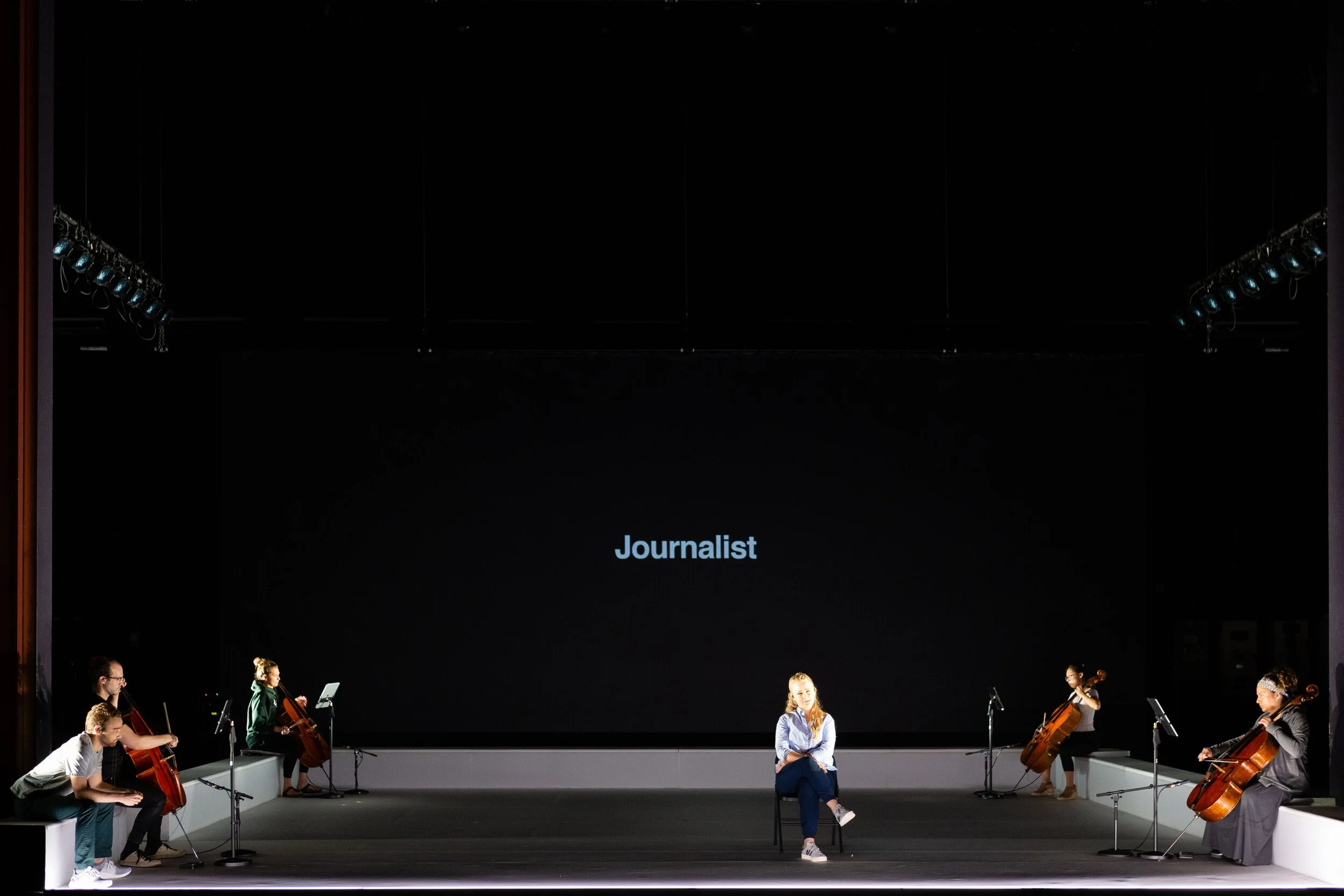 The Journalist portrayed by Theo Hoffman and Siena Licht Miller has a moment on stage accompanied by four cellos. Photo by Dominic M. Mercier; courtesy of Opera Philadelphia.