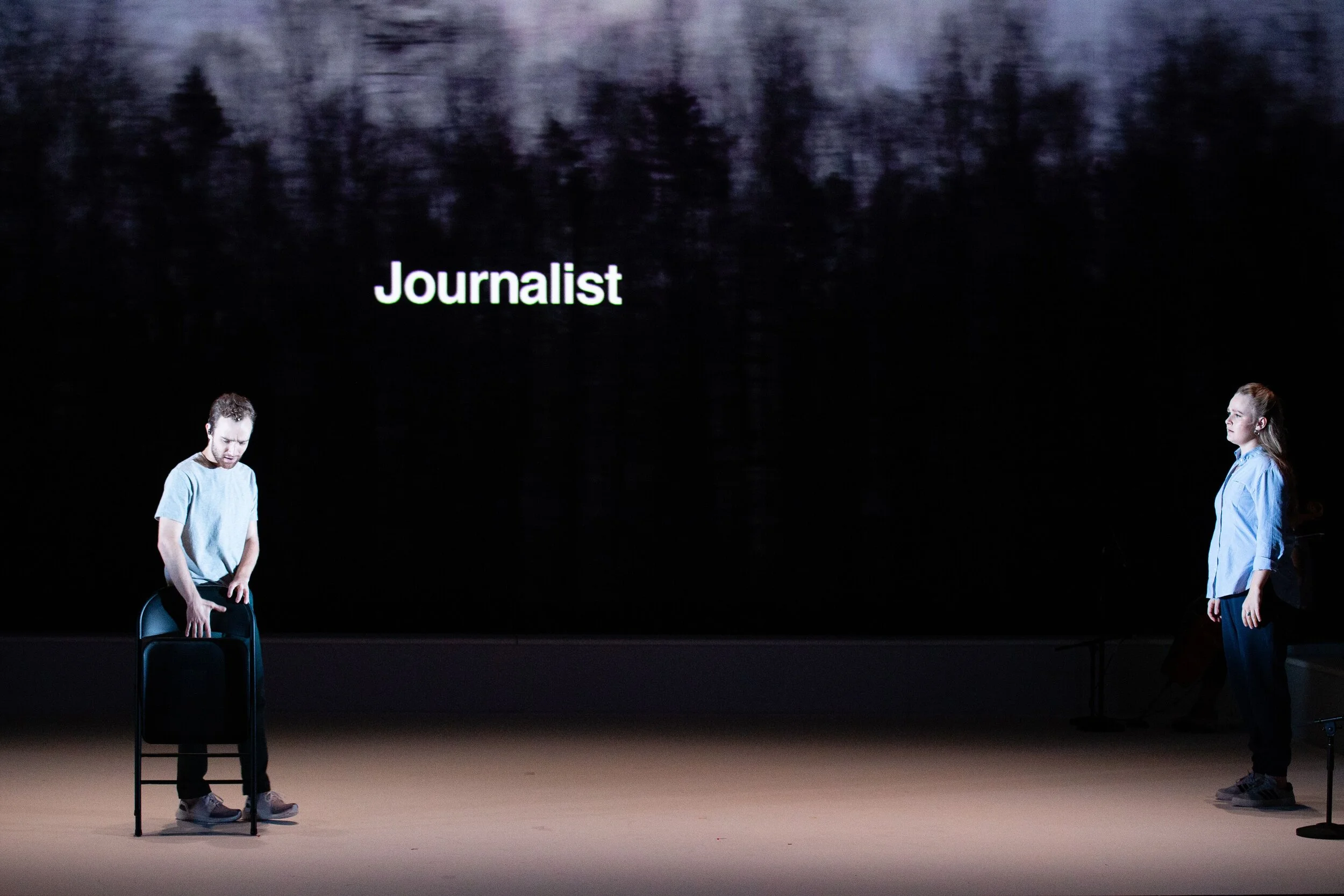 Shapes and footage as well as text appear on the screens. Photo by Dominic M. Mercier; courtesy of Opera Philadelphia.
