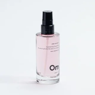 Pink Coconut Hydrating Face Mist in a clear bottle with a black spray cap.