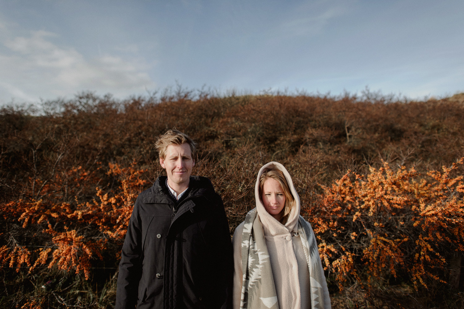 Couple standing in front of flowers