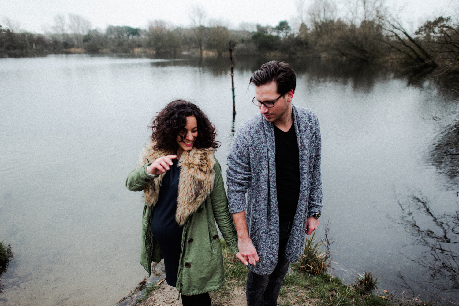Couple standing in front of lake