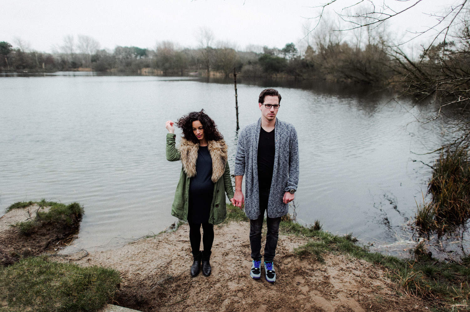 Couple standing in front of lake