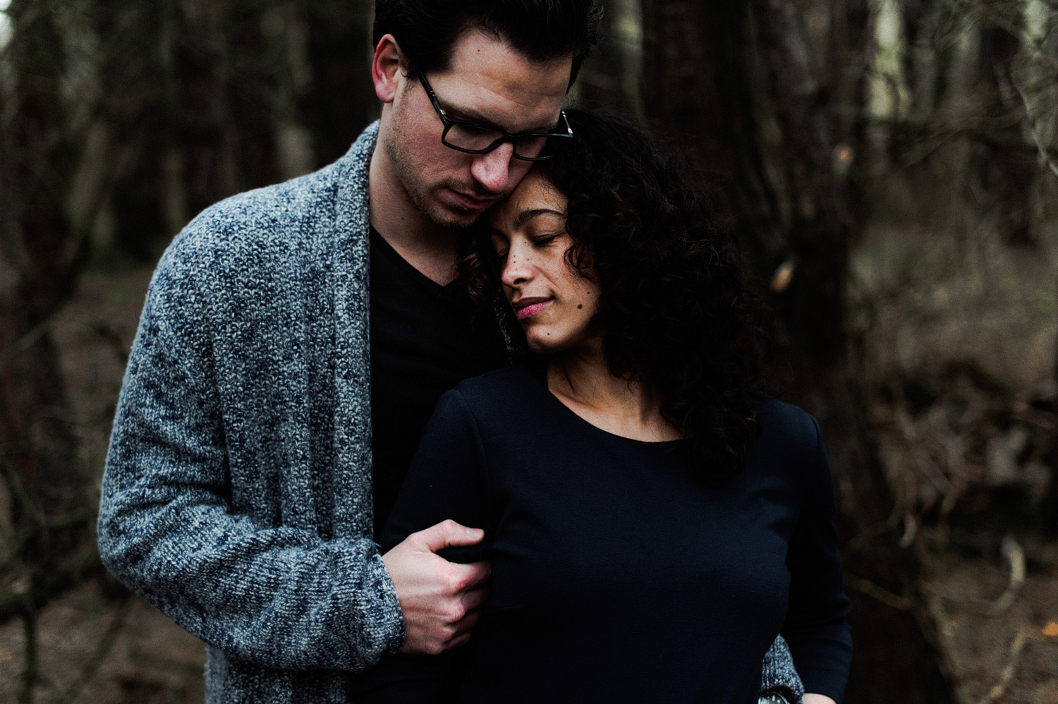 Close up of couple standing in forrest