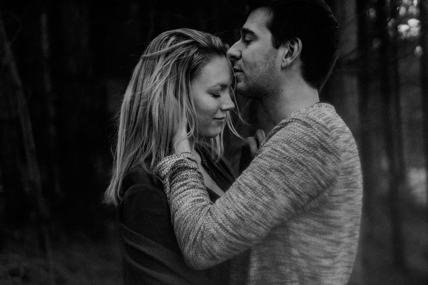 Guy kissing forehead of his girlfriend