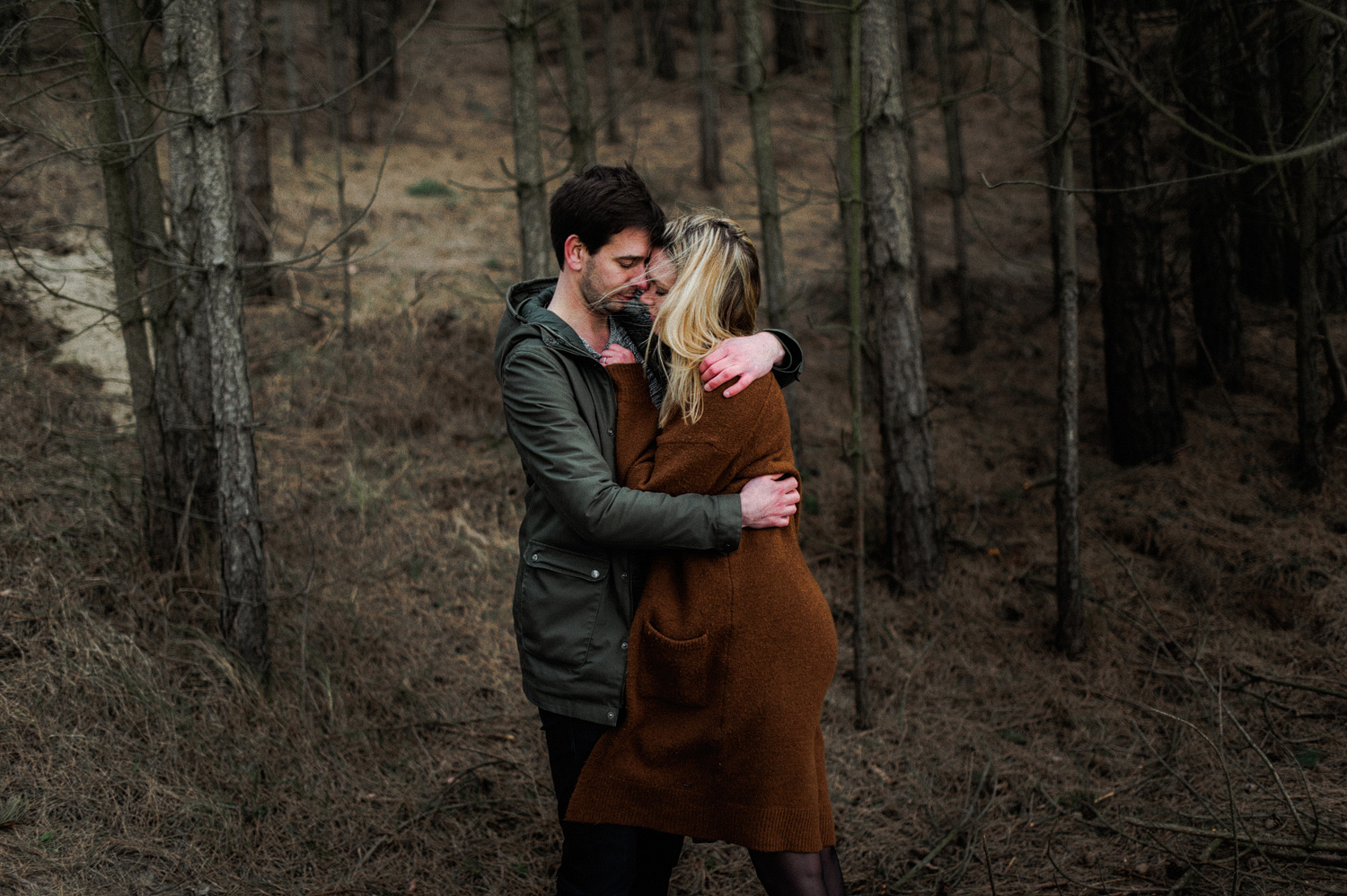 Couple hugging each other in the forrest
