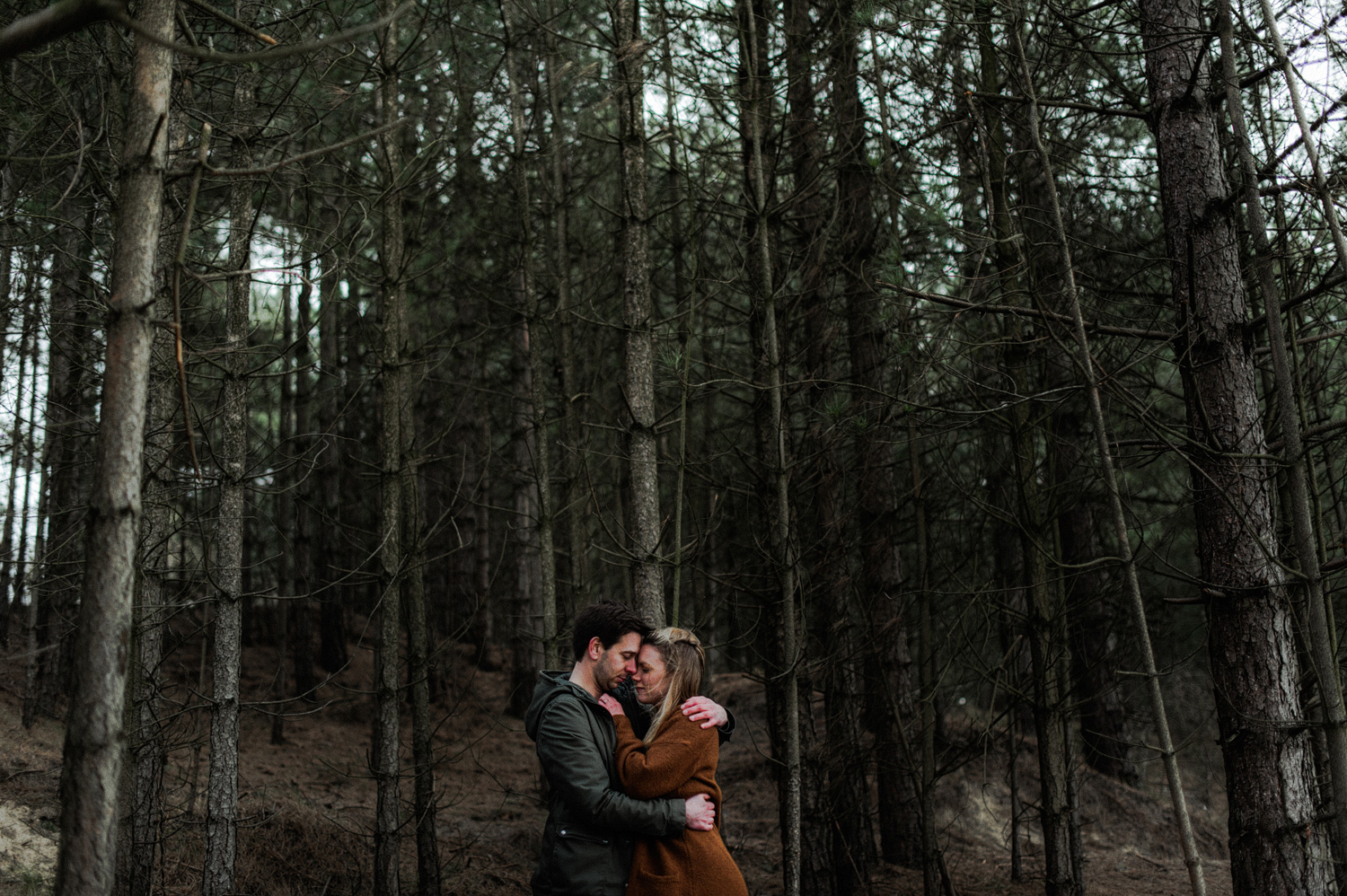 Couple hugging each other in the forrest
