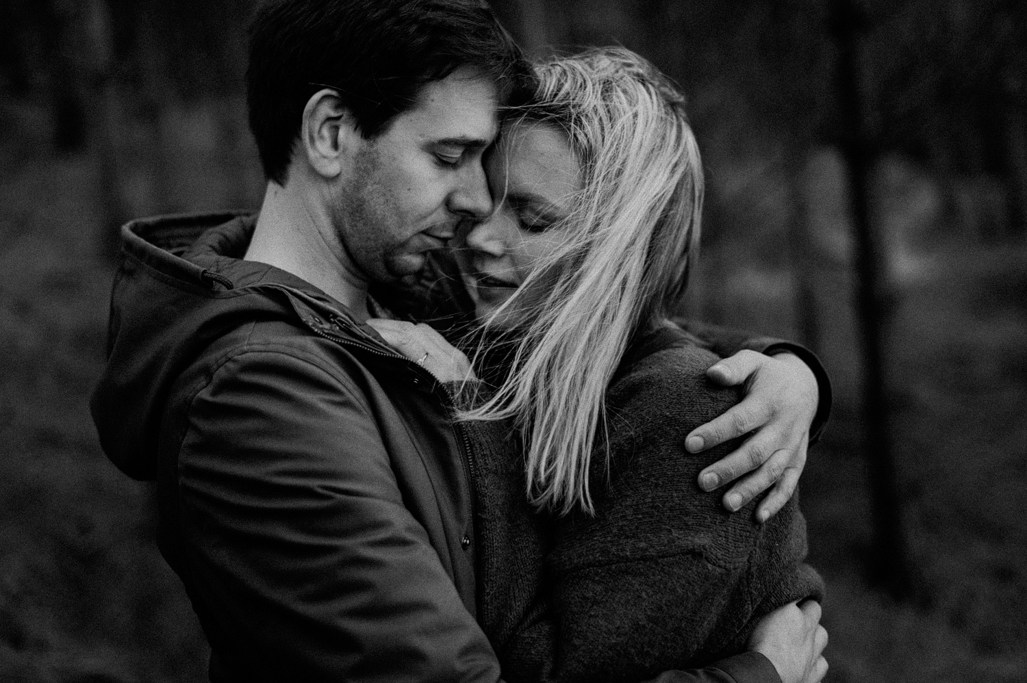 Couple hugging each other in the forrest