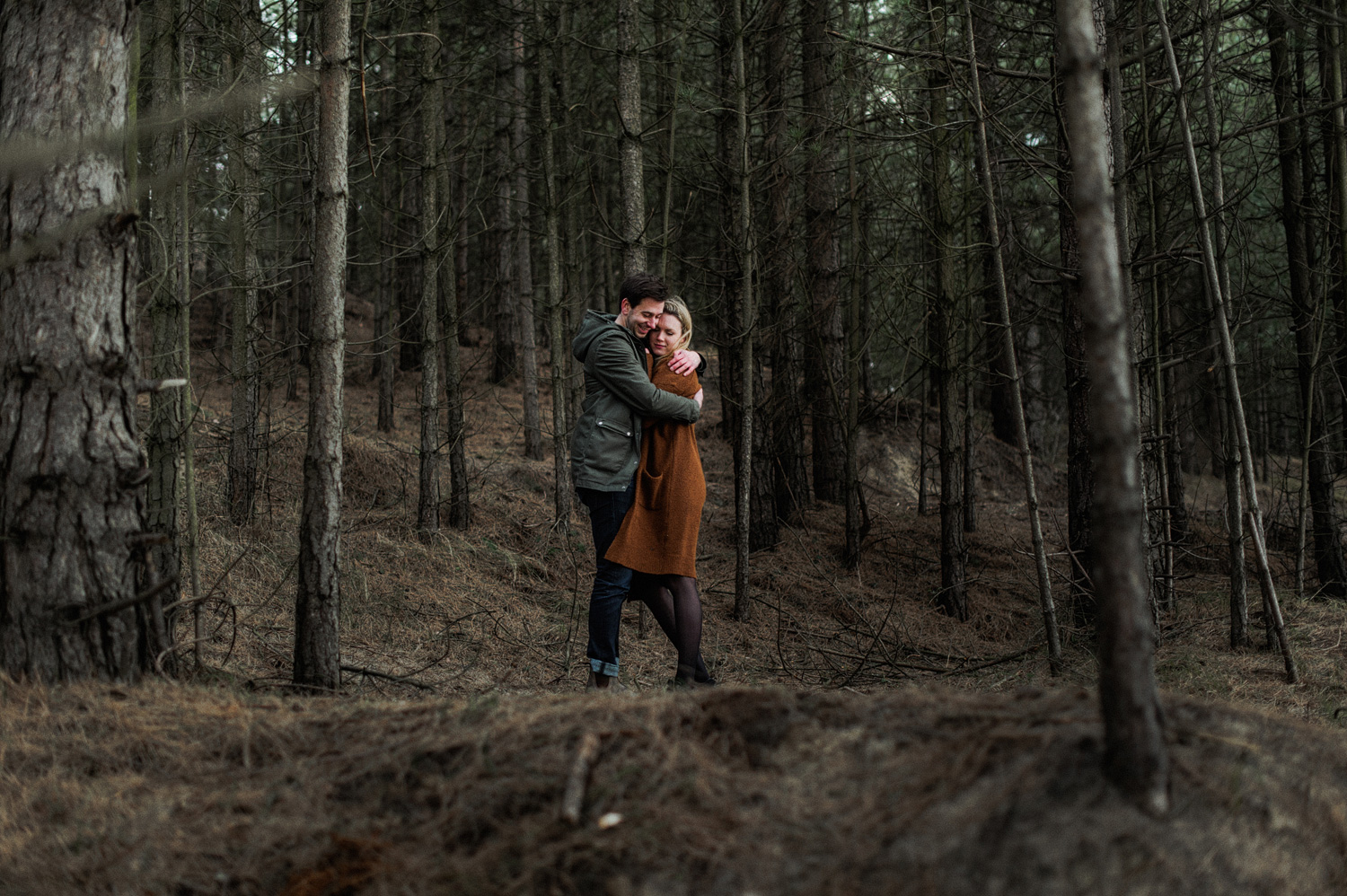 Couple hugging each other in the forrest