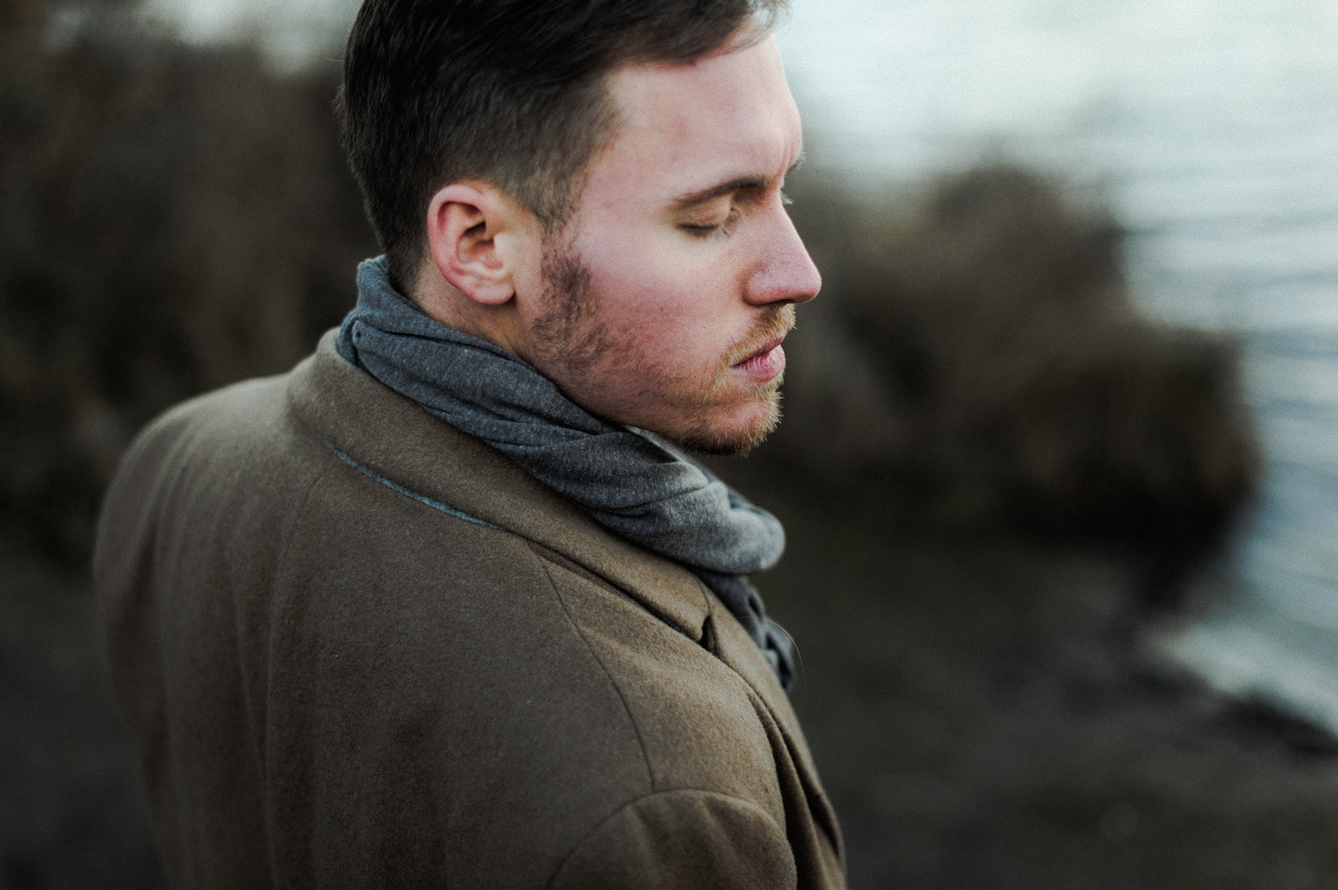 Close up portrait of guy in front of lake