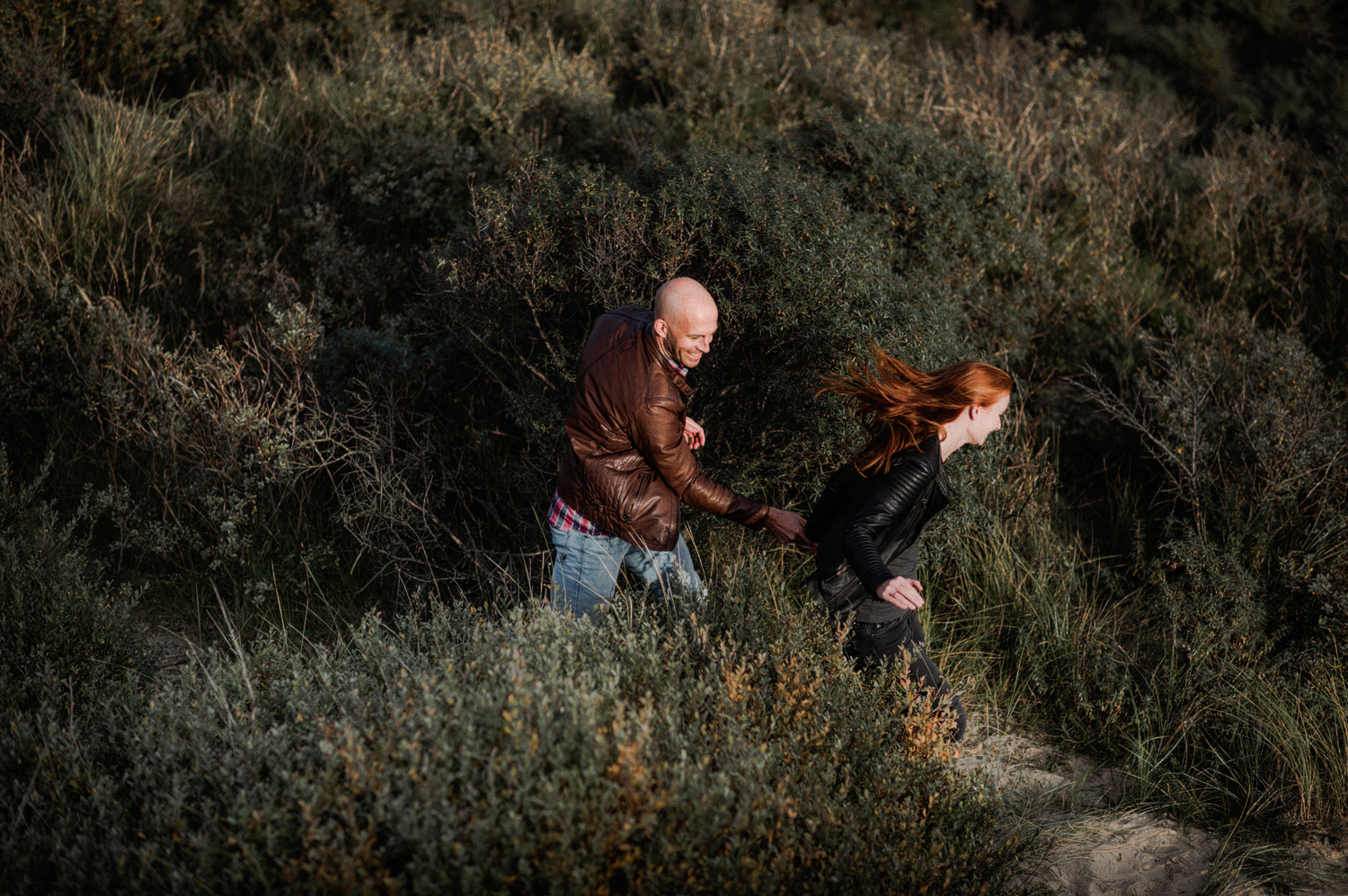 Couple running in the dunes