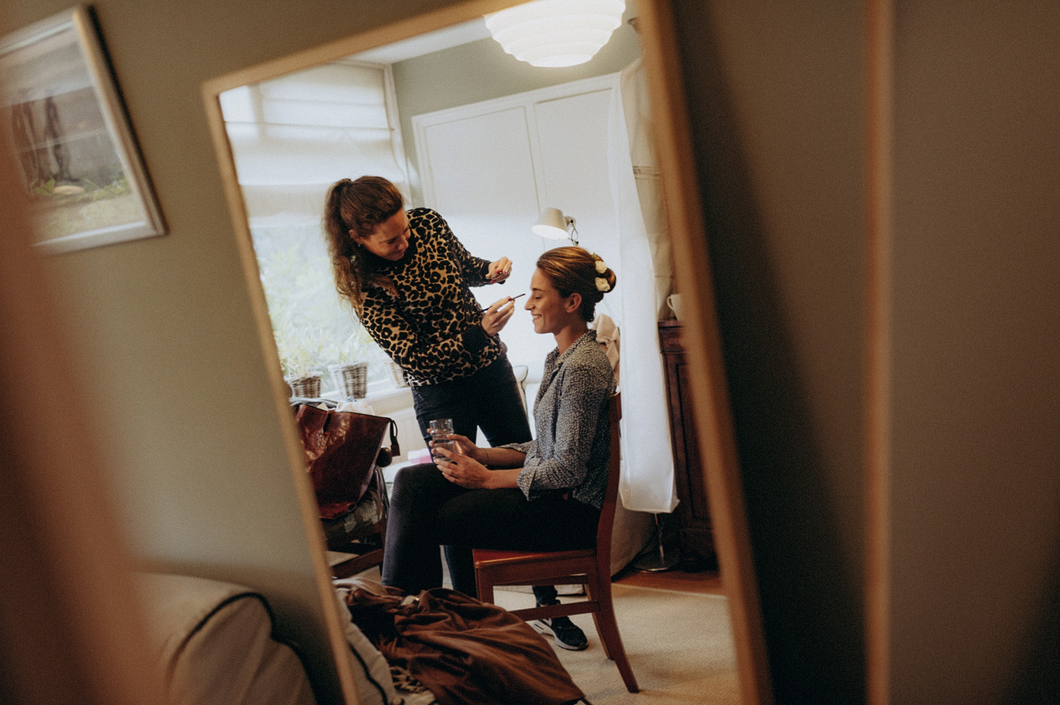 Bride getting her make-up done in mirror