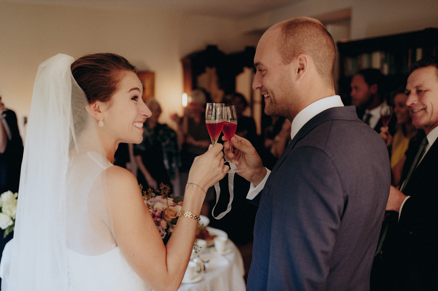 Groom and bride saying cheers with glasses of champagne