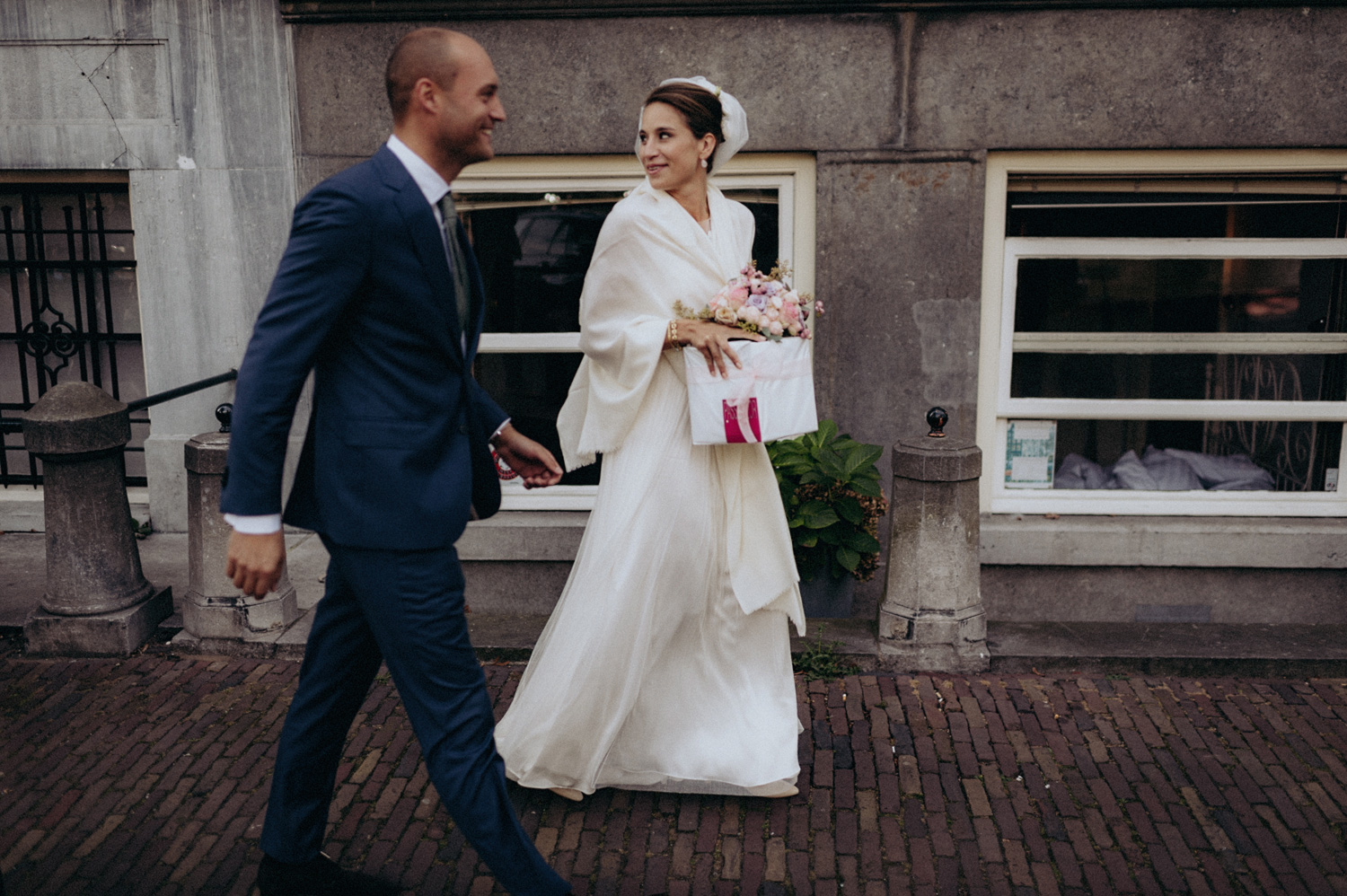 Bride and groom walking in Amsterdam