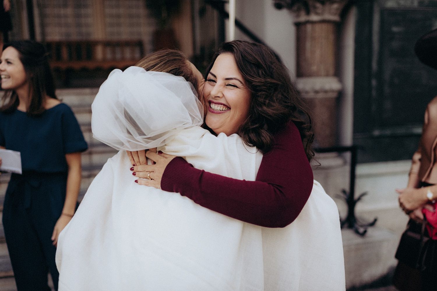 Best friend of bride hugging with smile