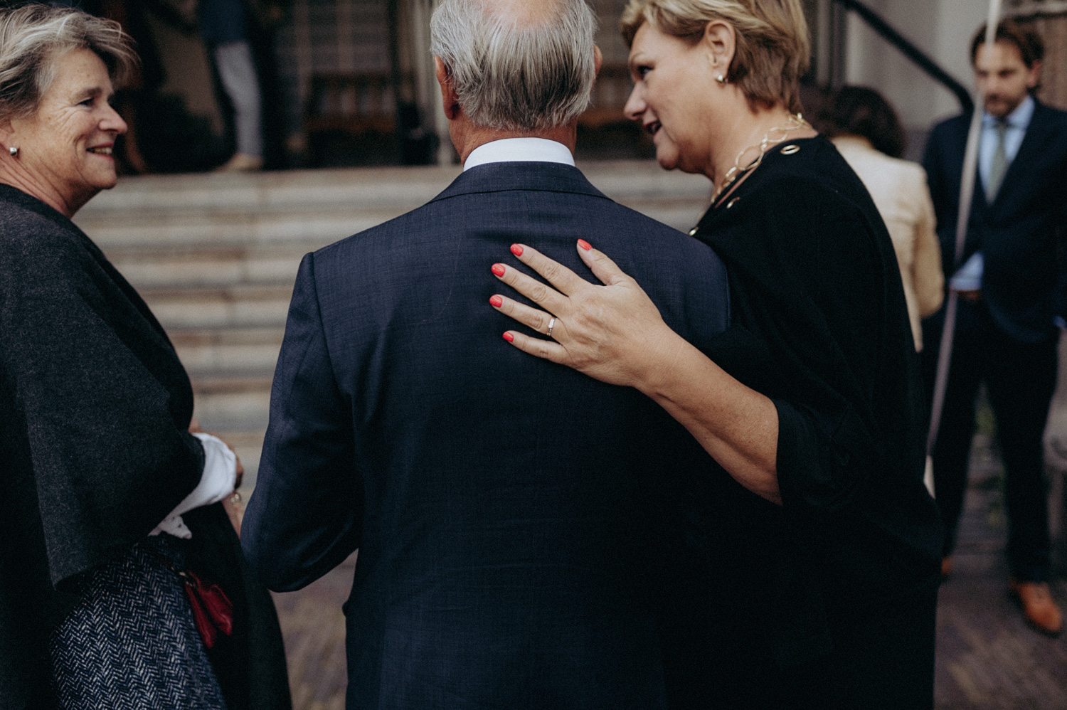 Hand on the back of wedding guest