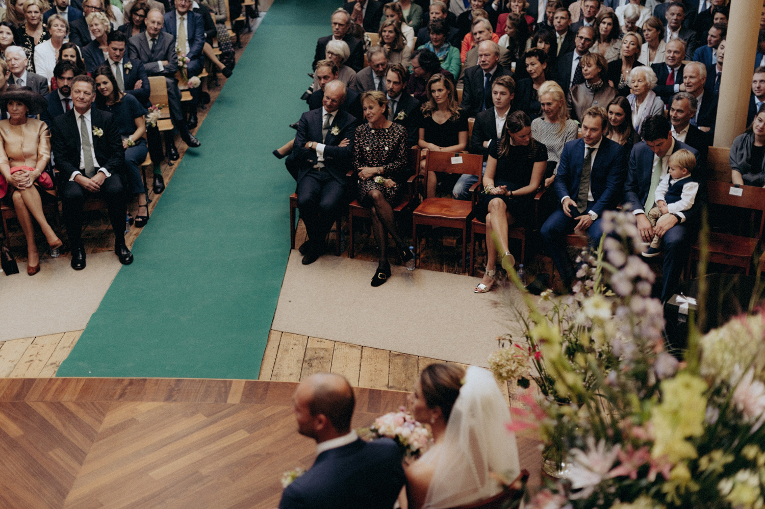 Bride and groom looking at their wedding guests in Keizersgracht Kerk Amsterdam