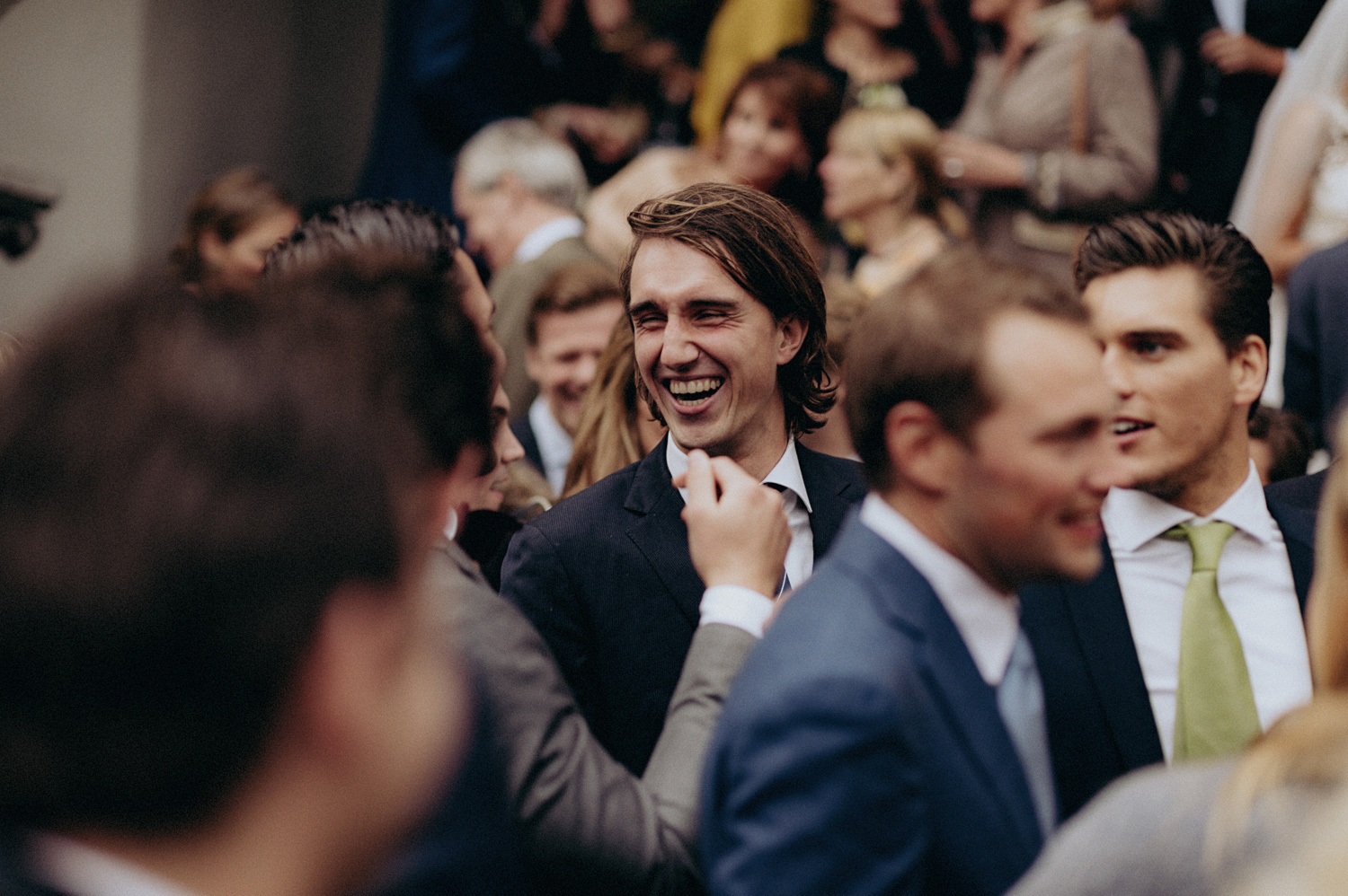 Wedding guests smiling and laughing